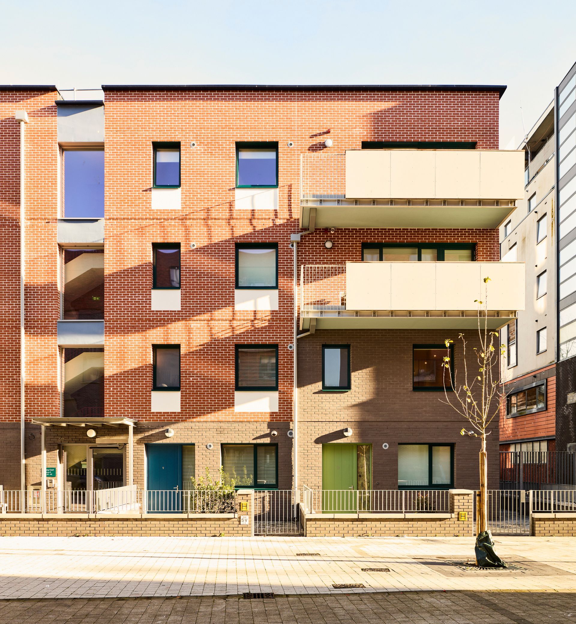A brick building with a lot of windows and balconies