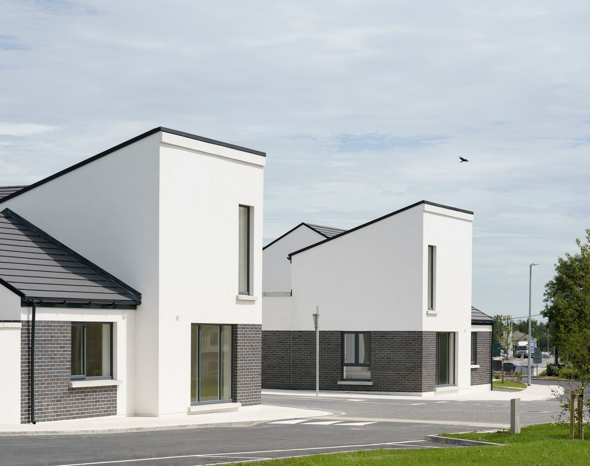 A row of white houses with black roofs