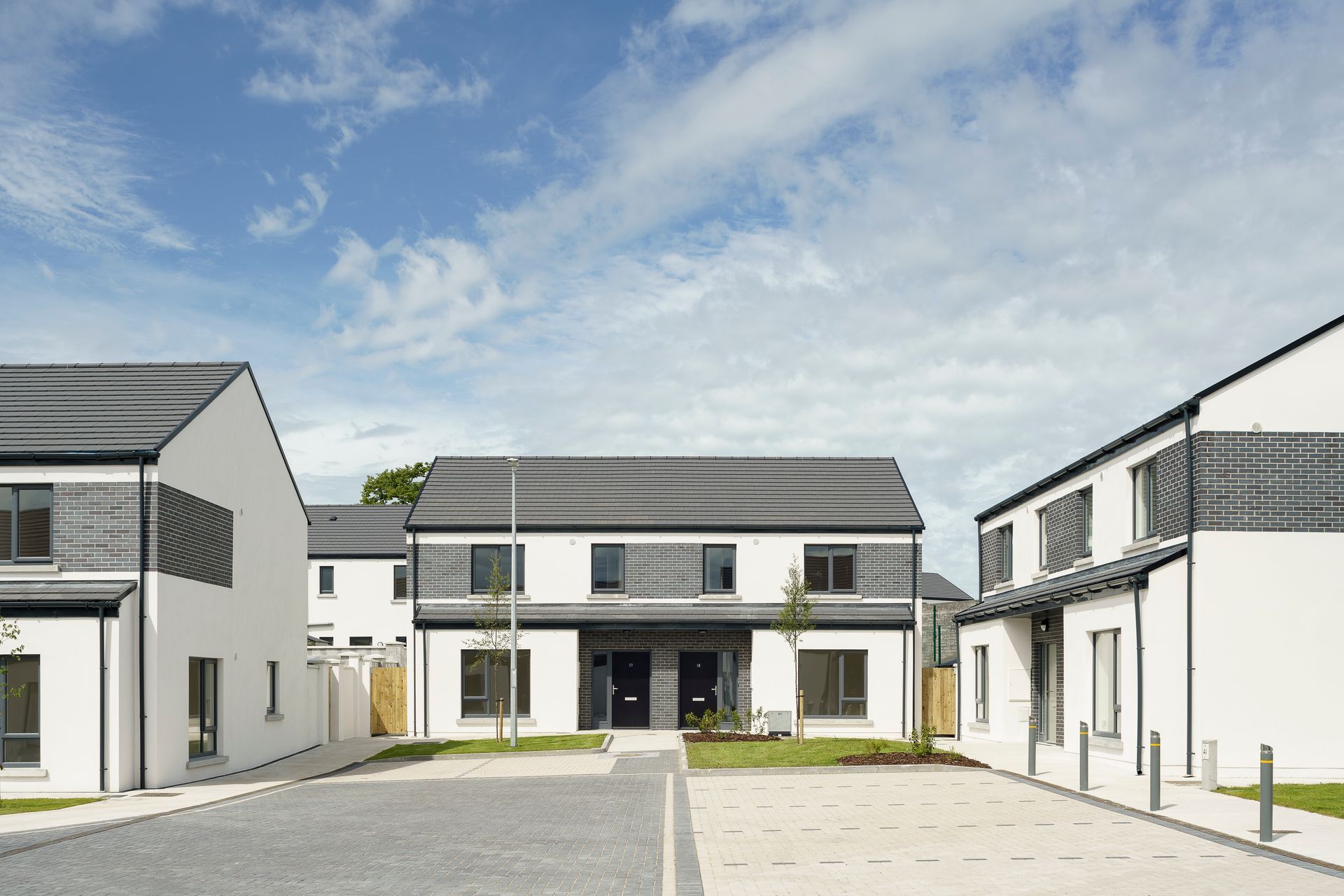 A row of houses are lined up next to each other on a sunny day.