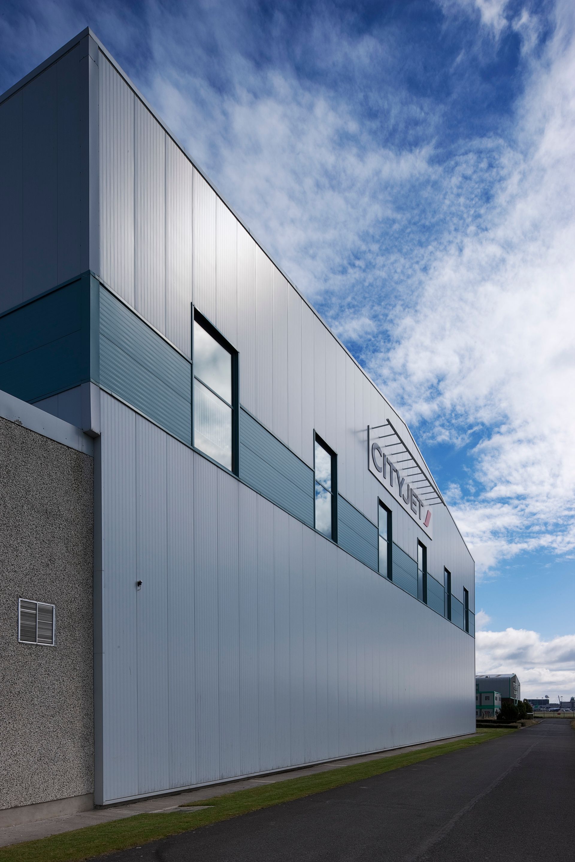 A large white building with a blue sky in the background
