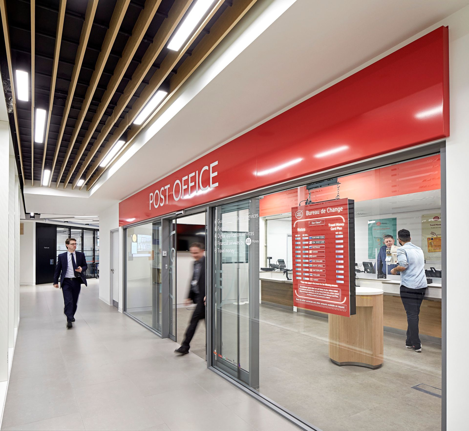 A post office with a red sign above the doors