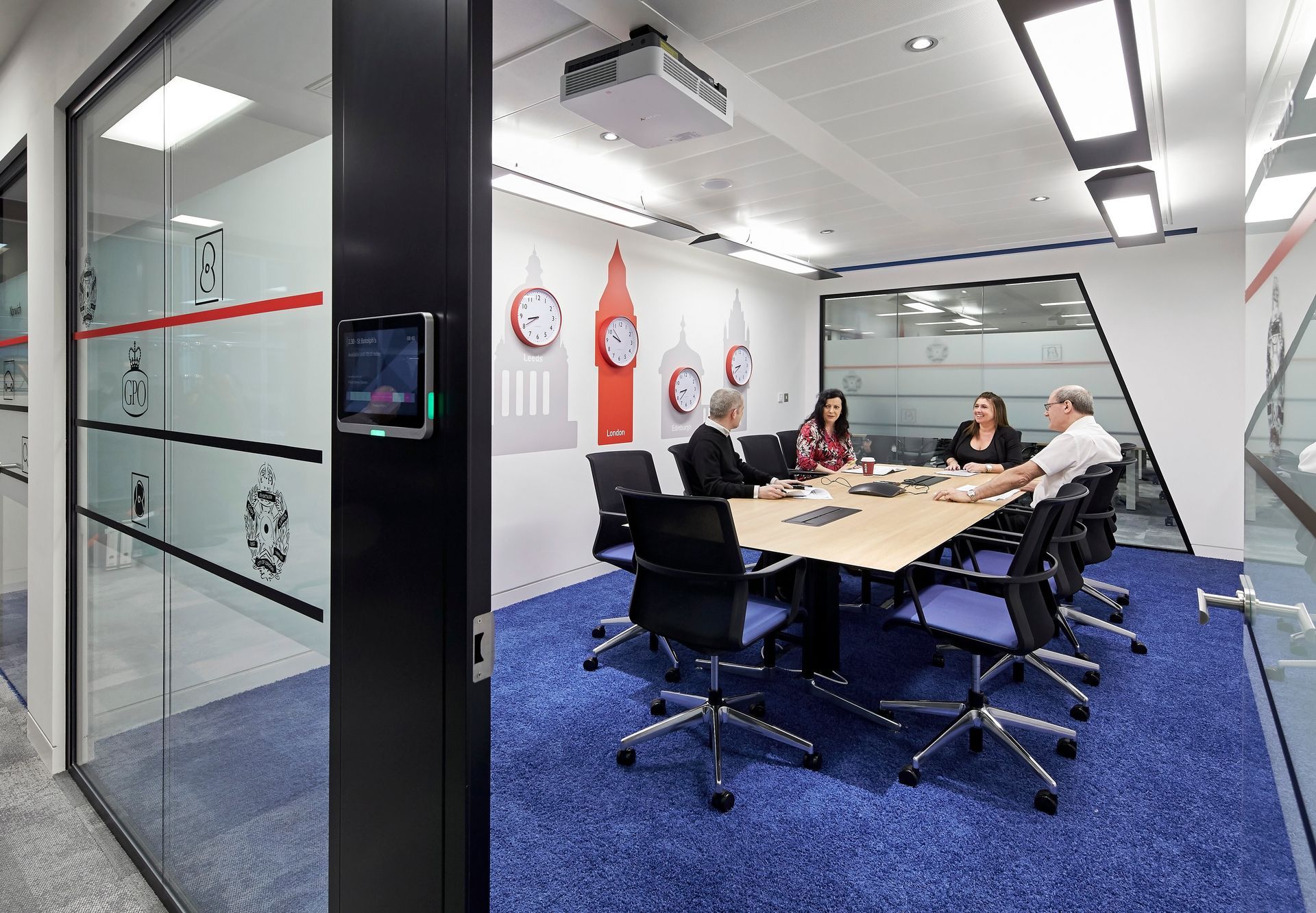 A group of people are sitting around a table in a conference room.