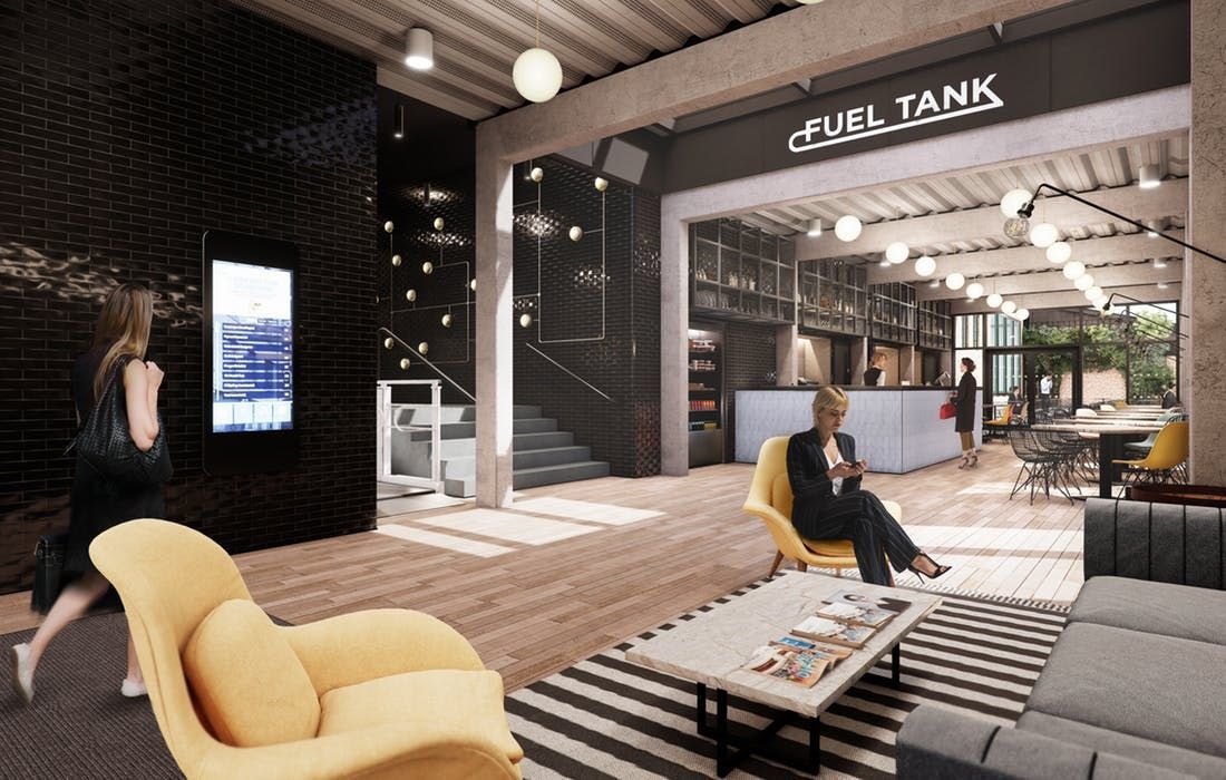 A woman is sitting in a yellow chair in a living room.