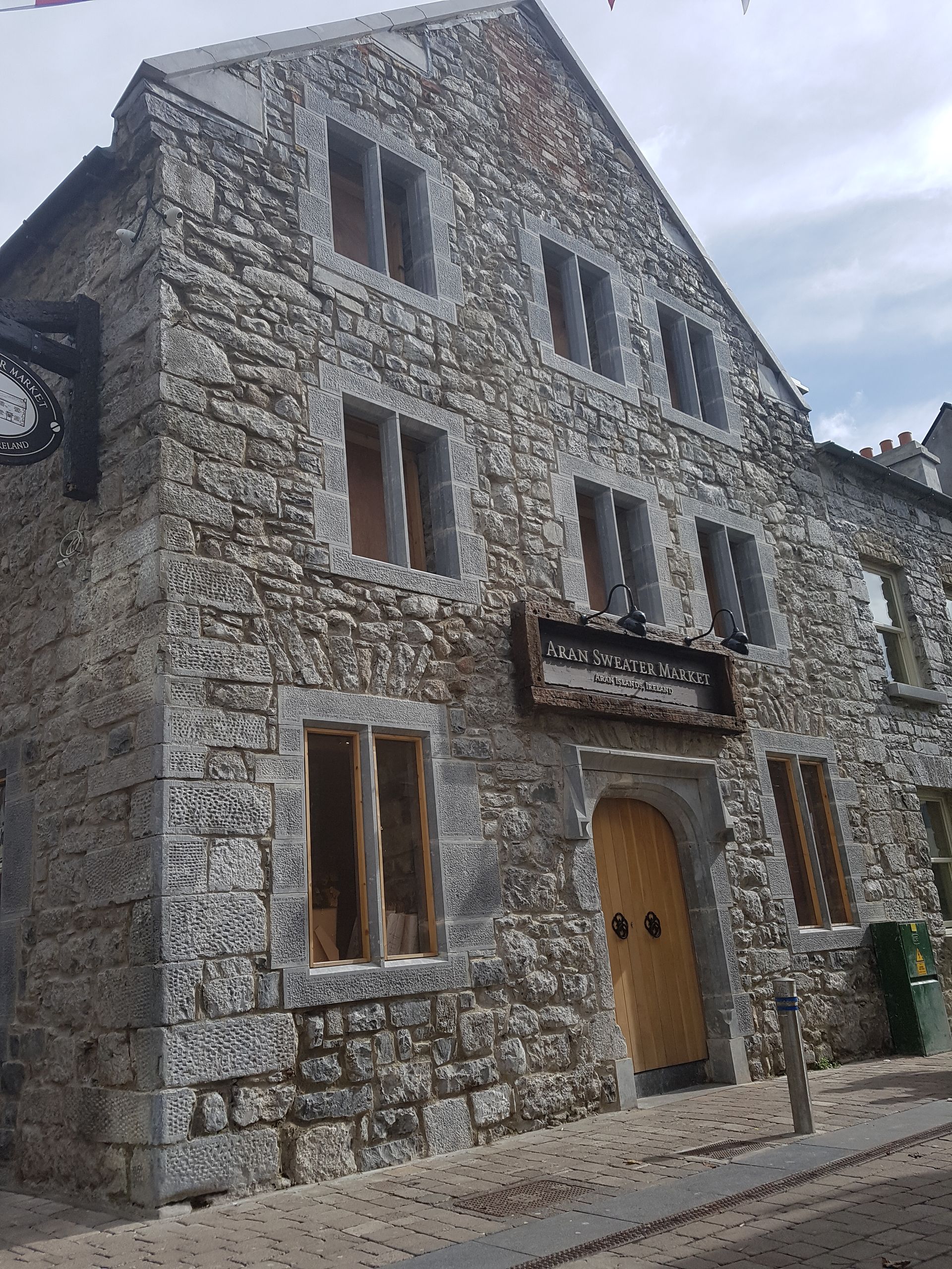 A large stone building with a wooden door and windows