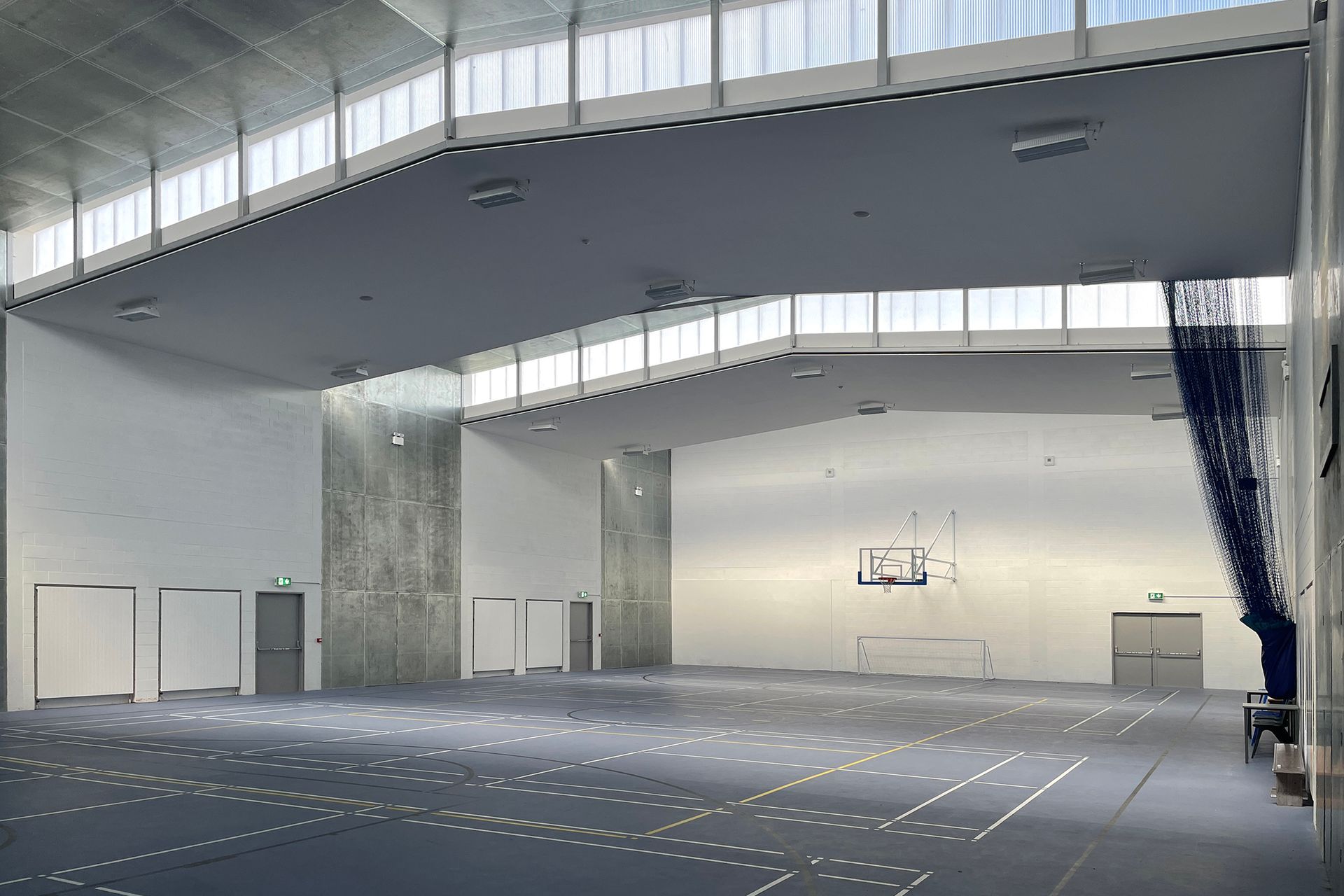 A large empty room with a lot of windows and doors