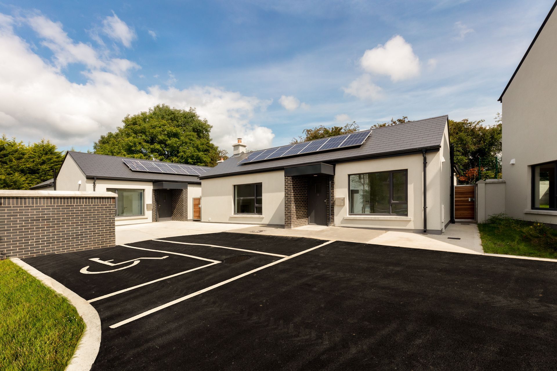A house with a handicapped parking spot in front of it.