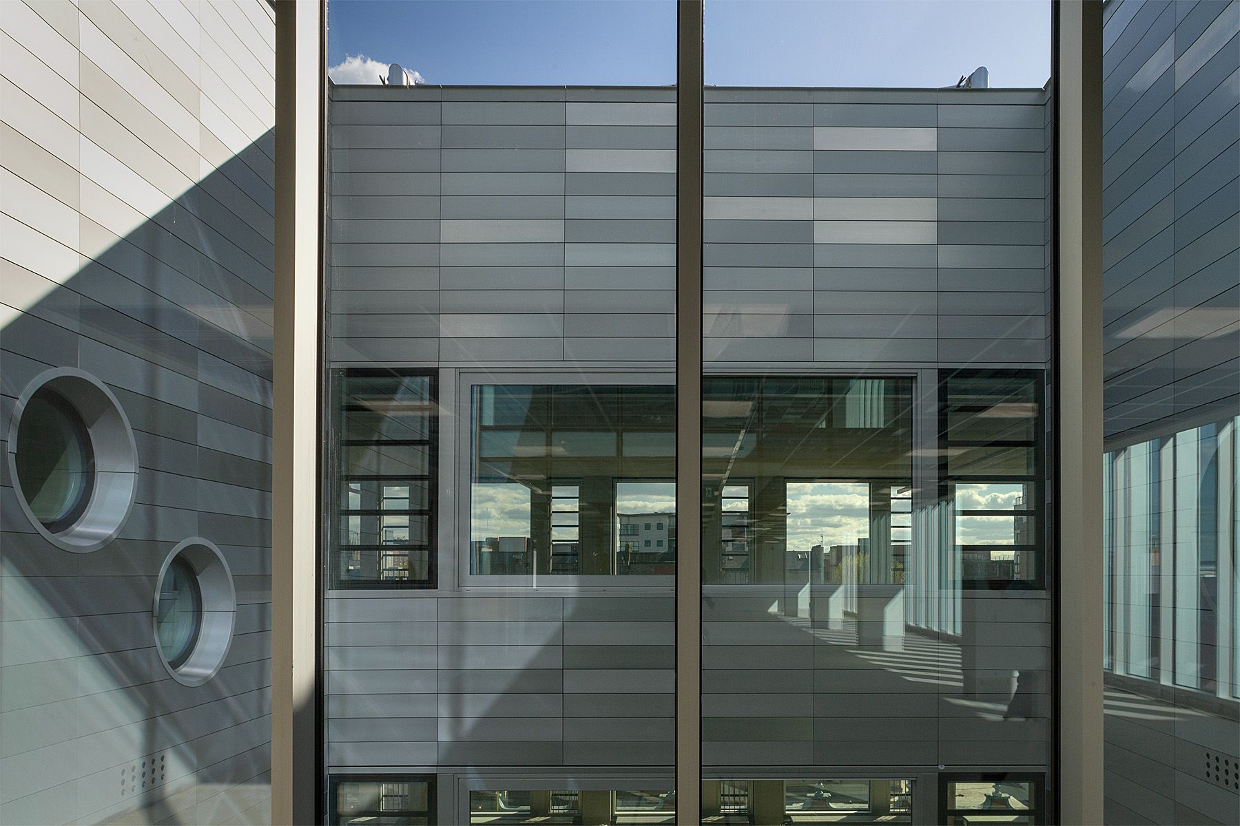 A building with a lot of windows and a blue sky in the background