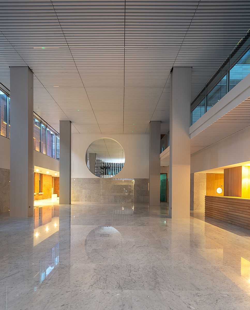 A large empty lobby with a large mirror on the wall