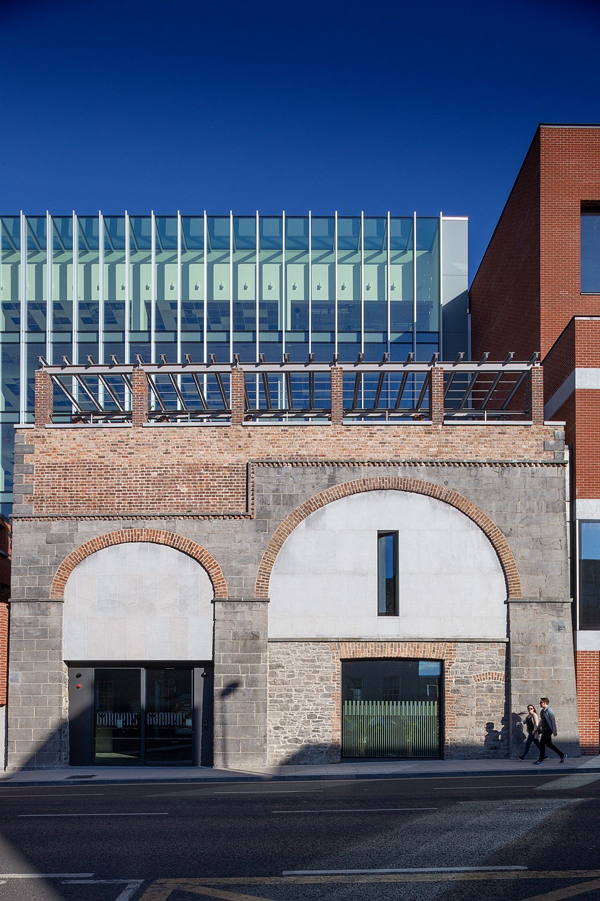 A building with a brick archway and a glass facade