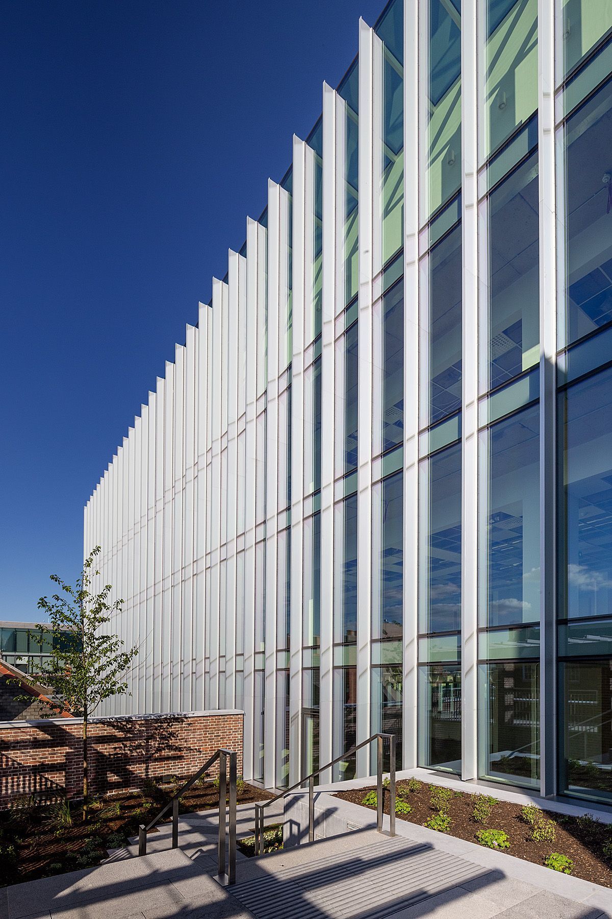 A large building with a lot of windows and stairs leading up to it.