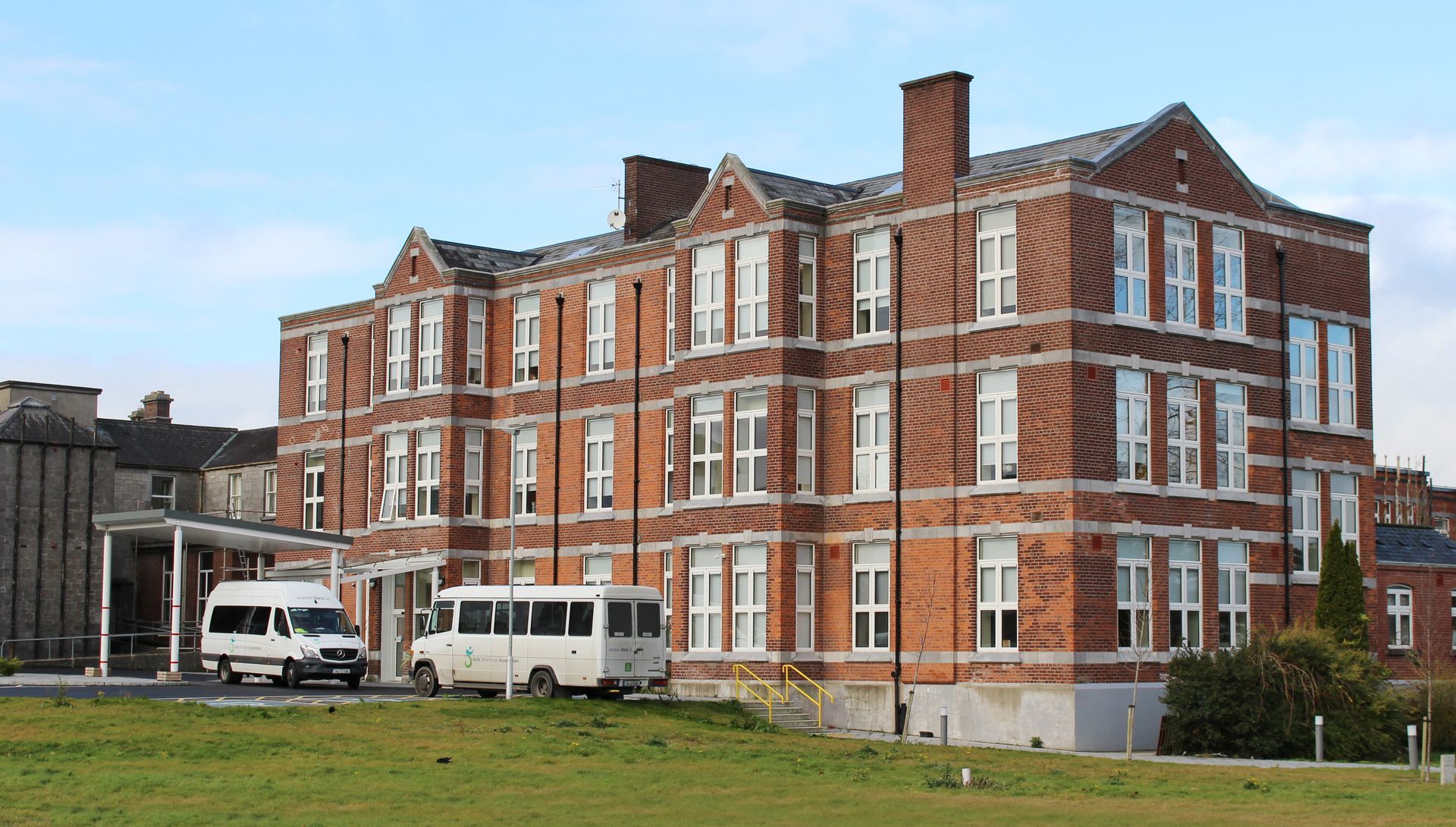 A large brick building with a white van parked in front of it