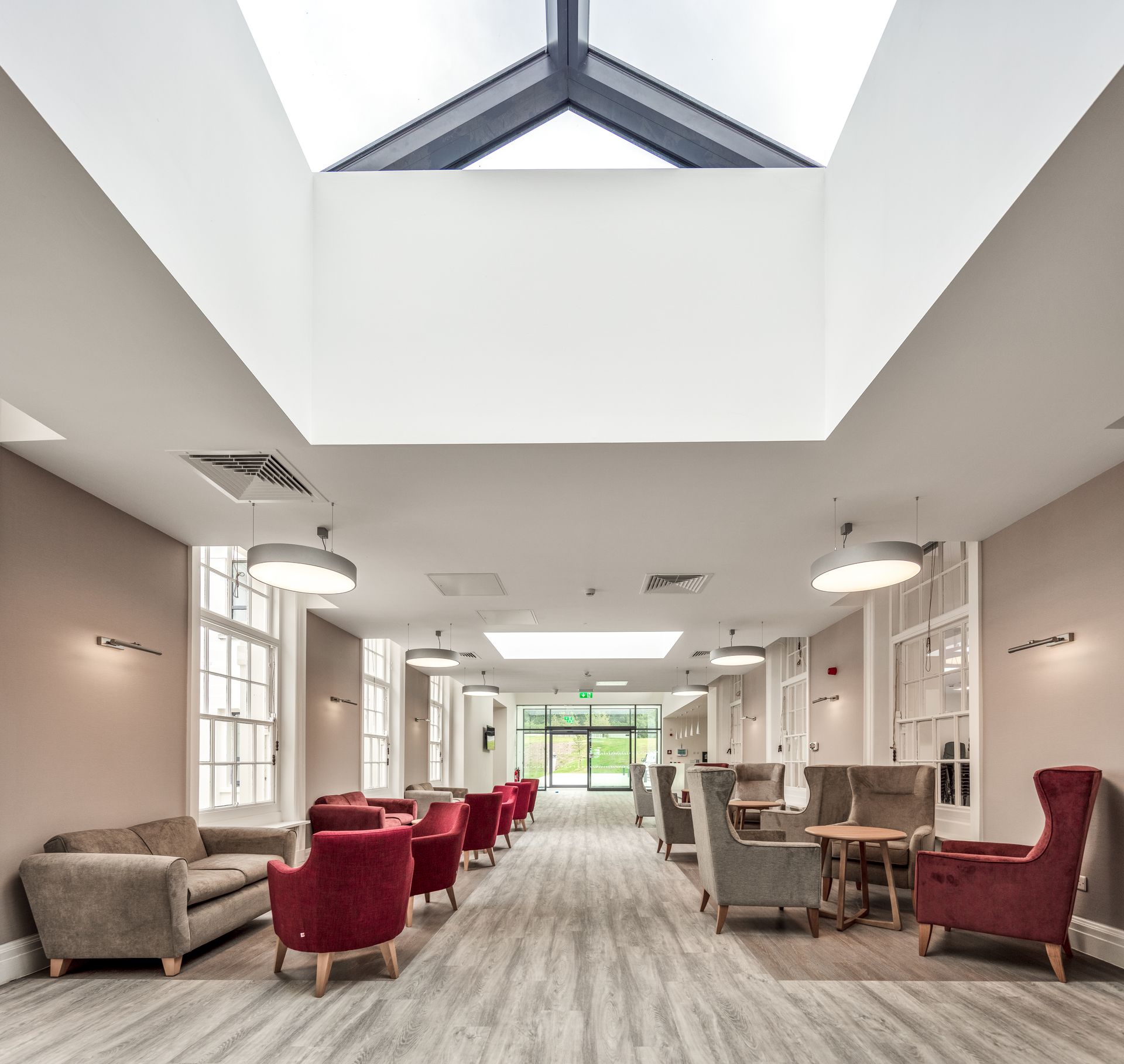 A large room with lots of furniture and a skylight