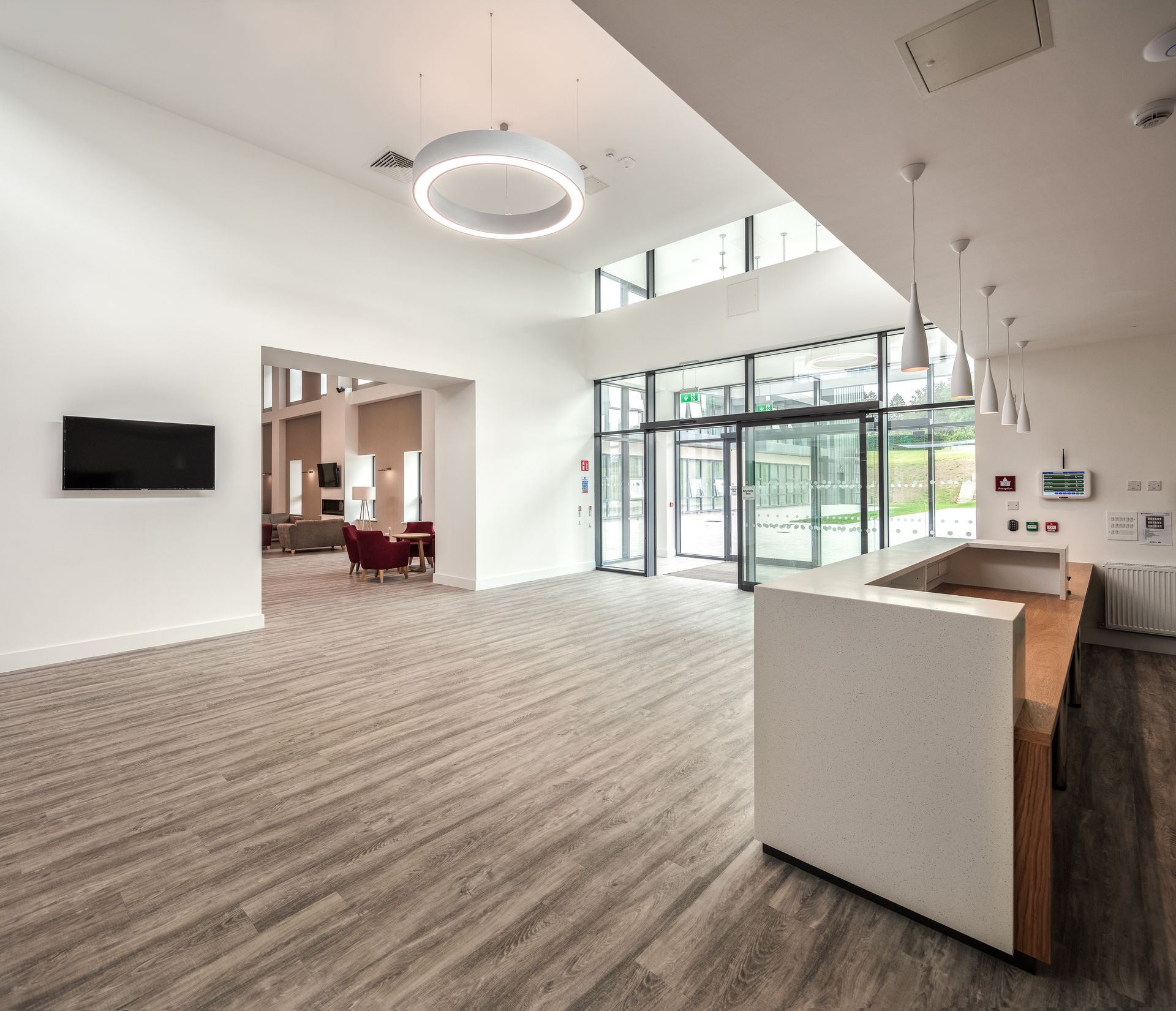 A large room with wooden floors and a white counter