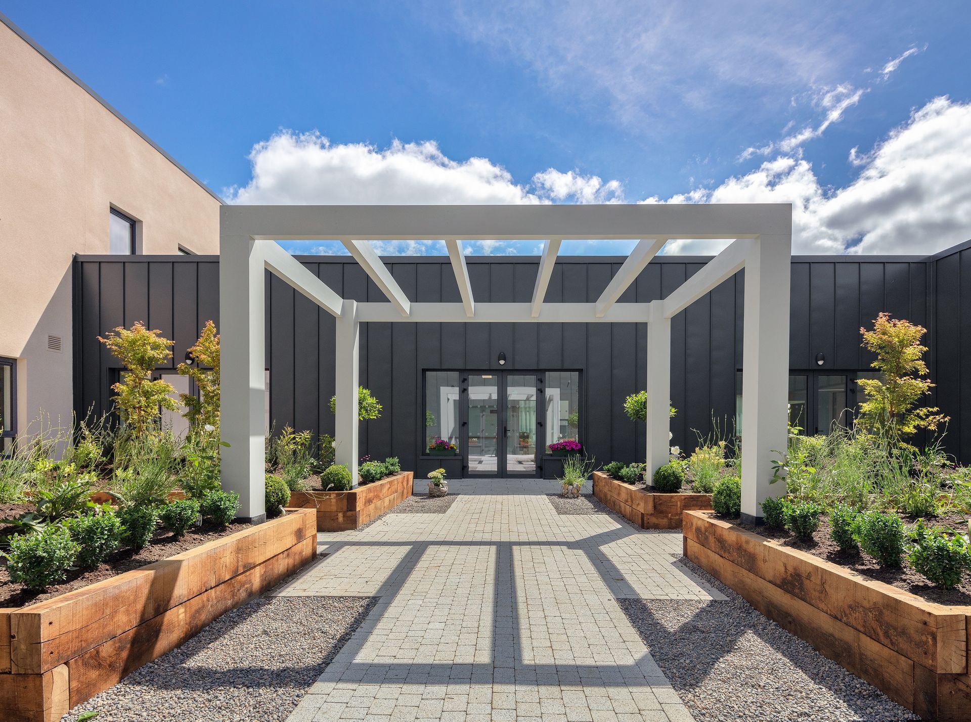 There is a walkway leading to the entrance of a building.