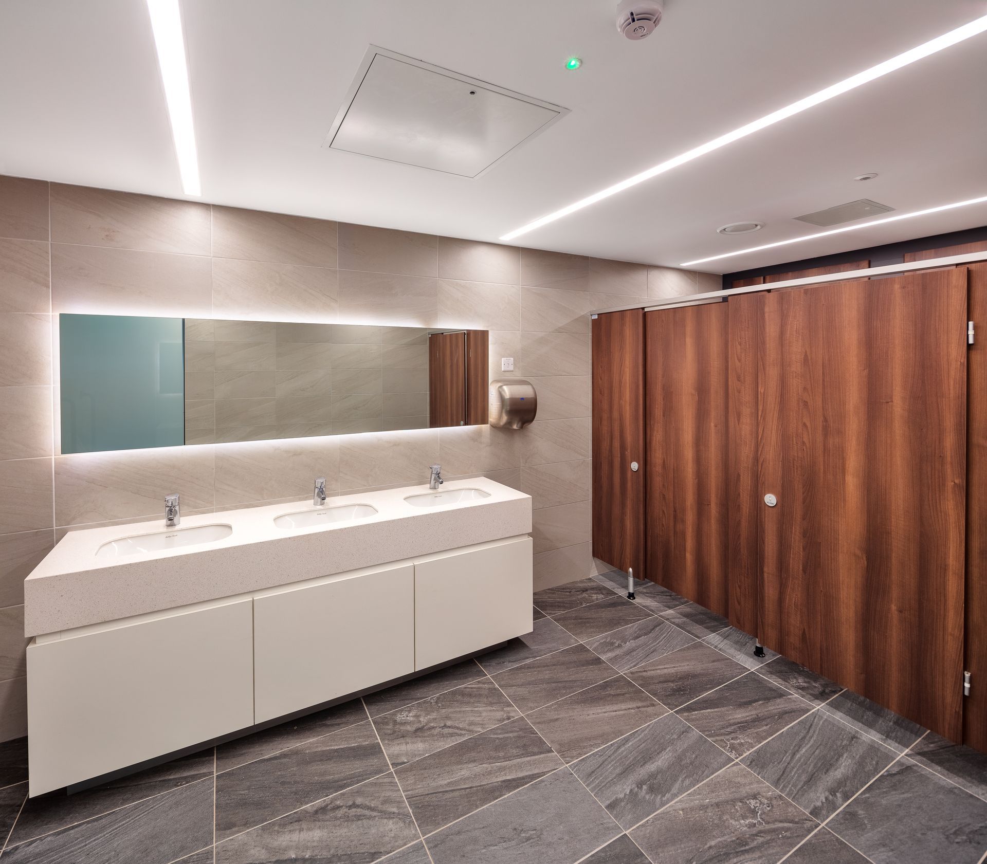 A bathroom with two sinks and a large mirror.