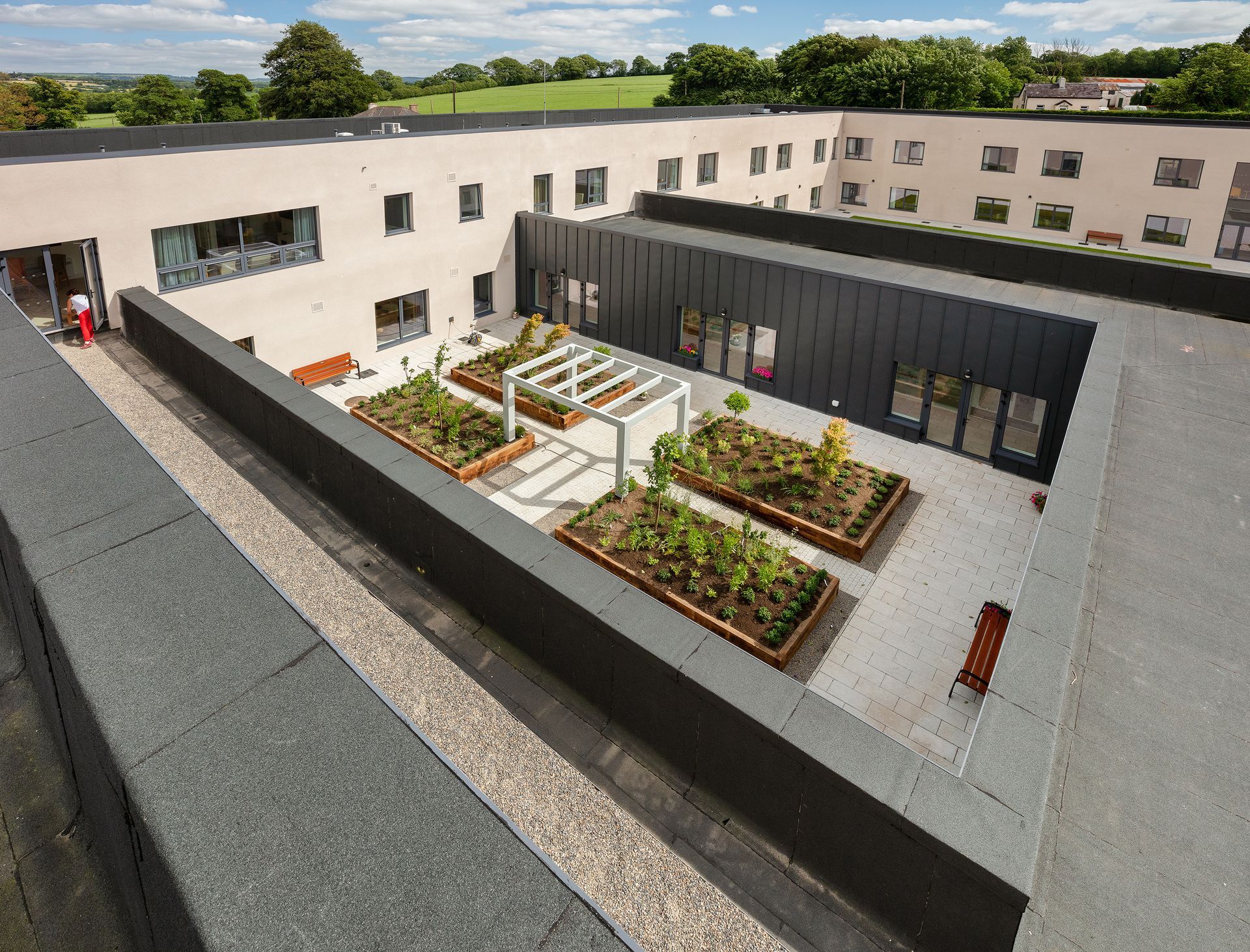 An aerial view of a building with a garden in the middle