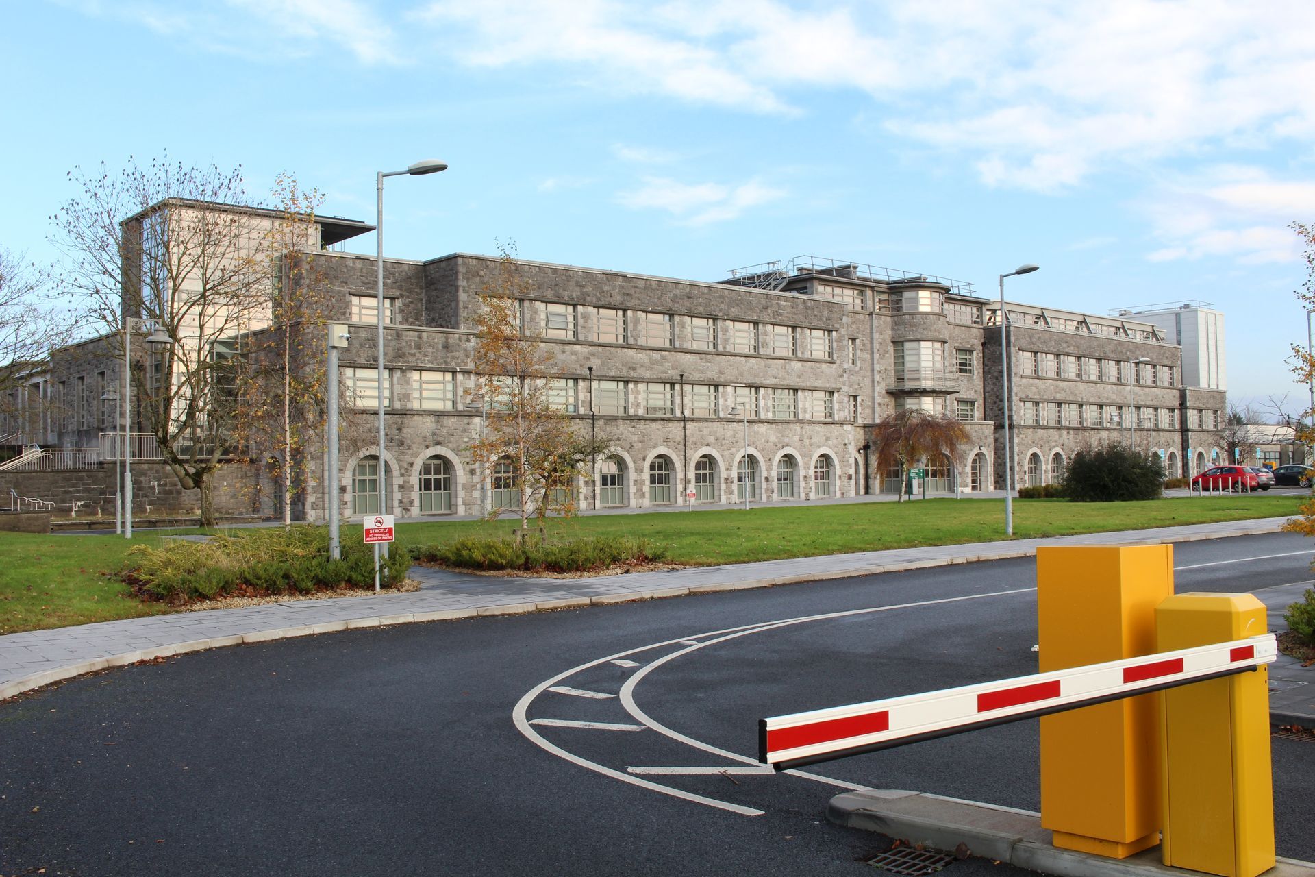 A large building with a yellow barrier in front of it