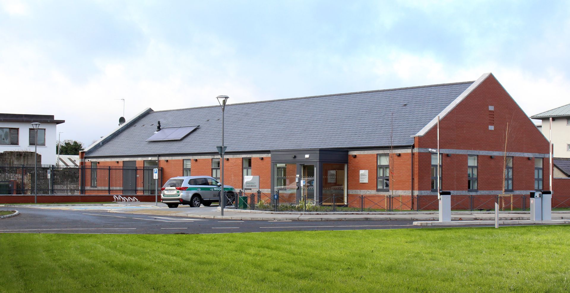 A large brick building with a car parked in front of it