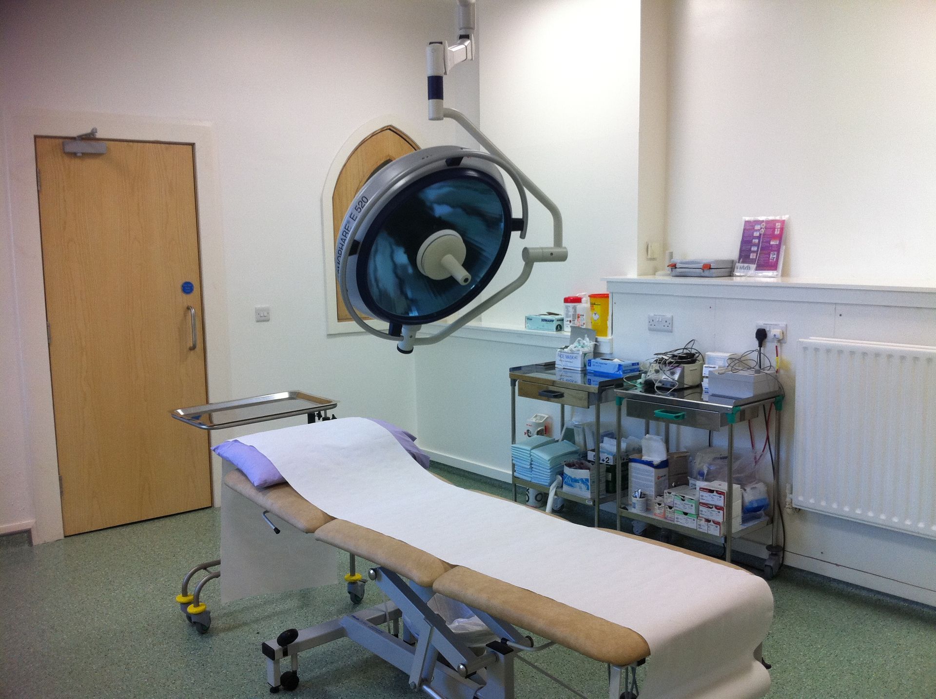 An operating room with a bed and an operating light