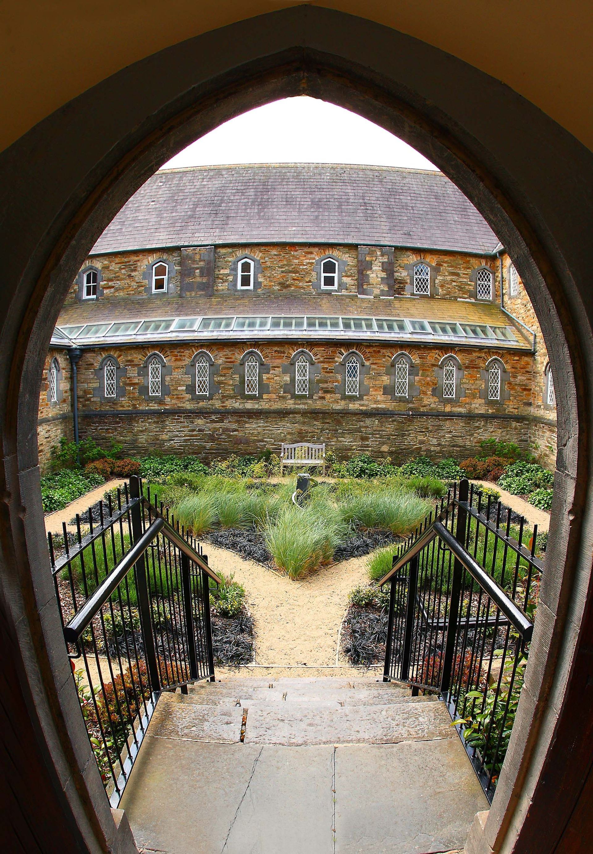 A view of a building through a window with stairs leading up to it