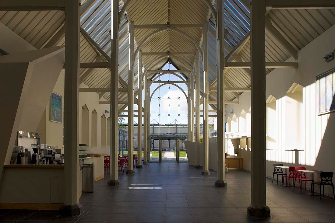 The inside of a building with columns and a large window.