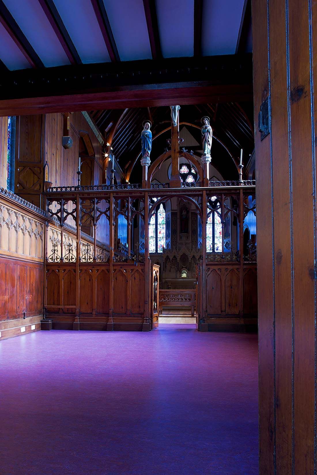 A church with purple carpet and a wooden door