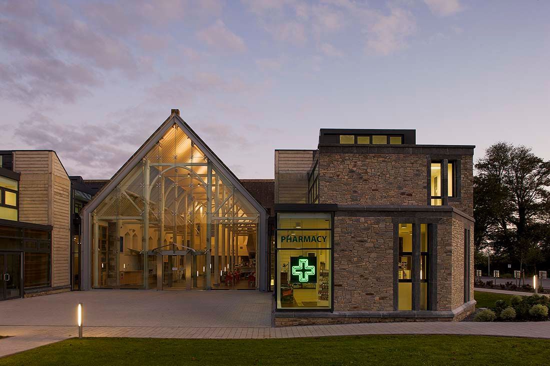 A large building with a green cross on the front of it.