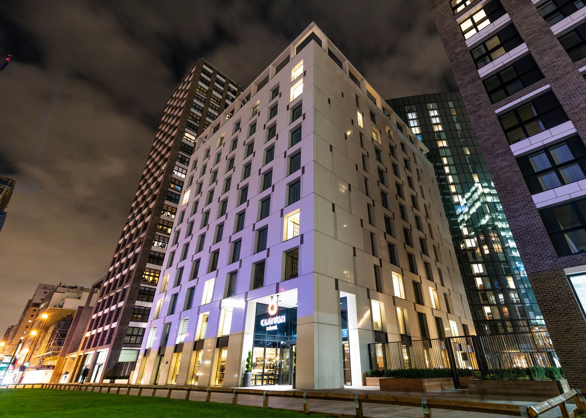 A large building with a lot of windows is lit up at night.