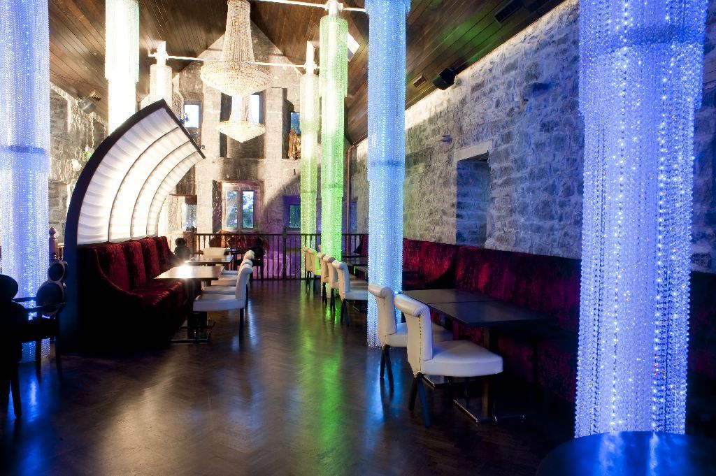 A restaurant with a lot of tables and chairs in it