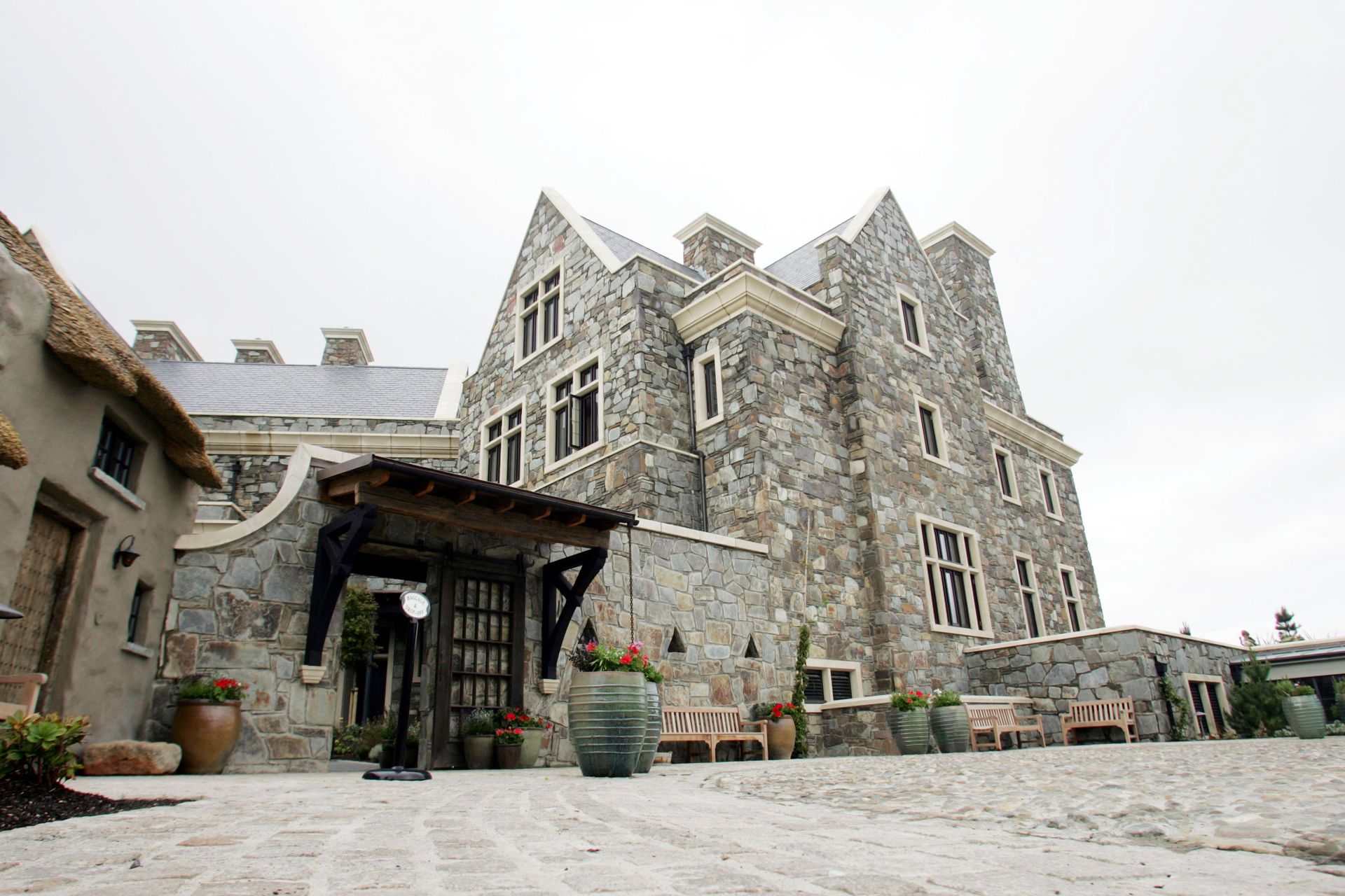 A large stone building with a thatched roof