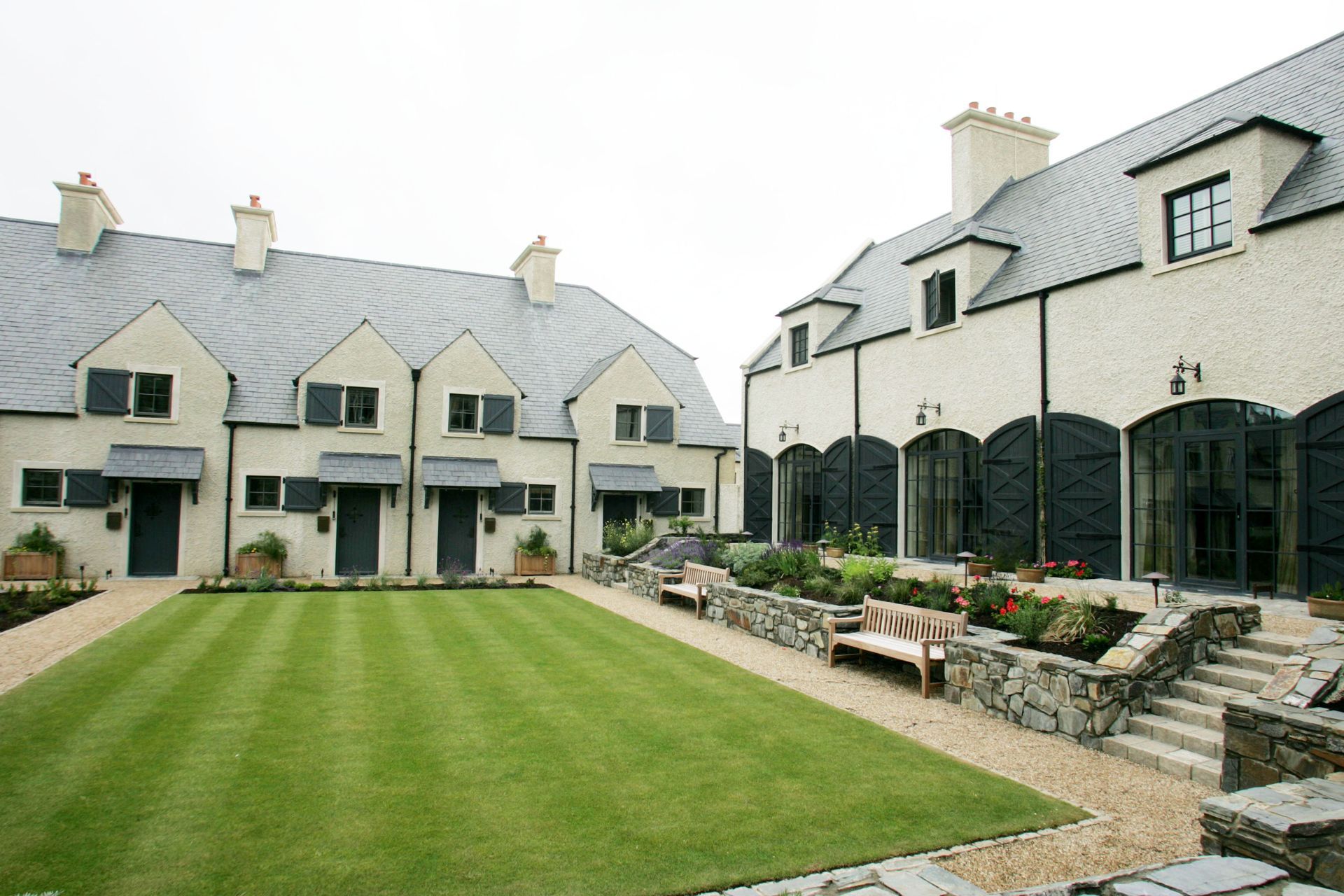 A row of houses with a large lawn in front of them