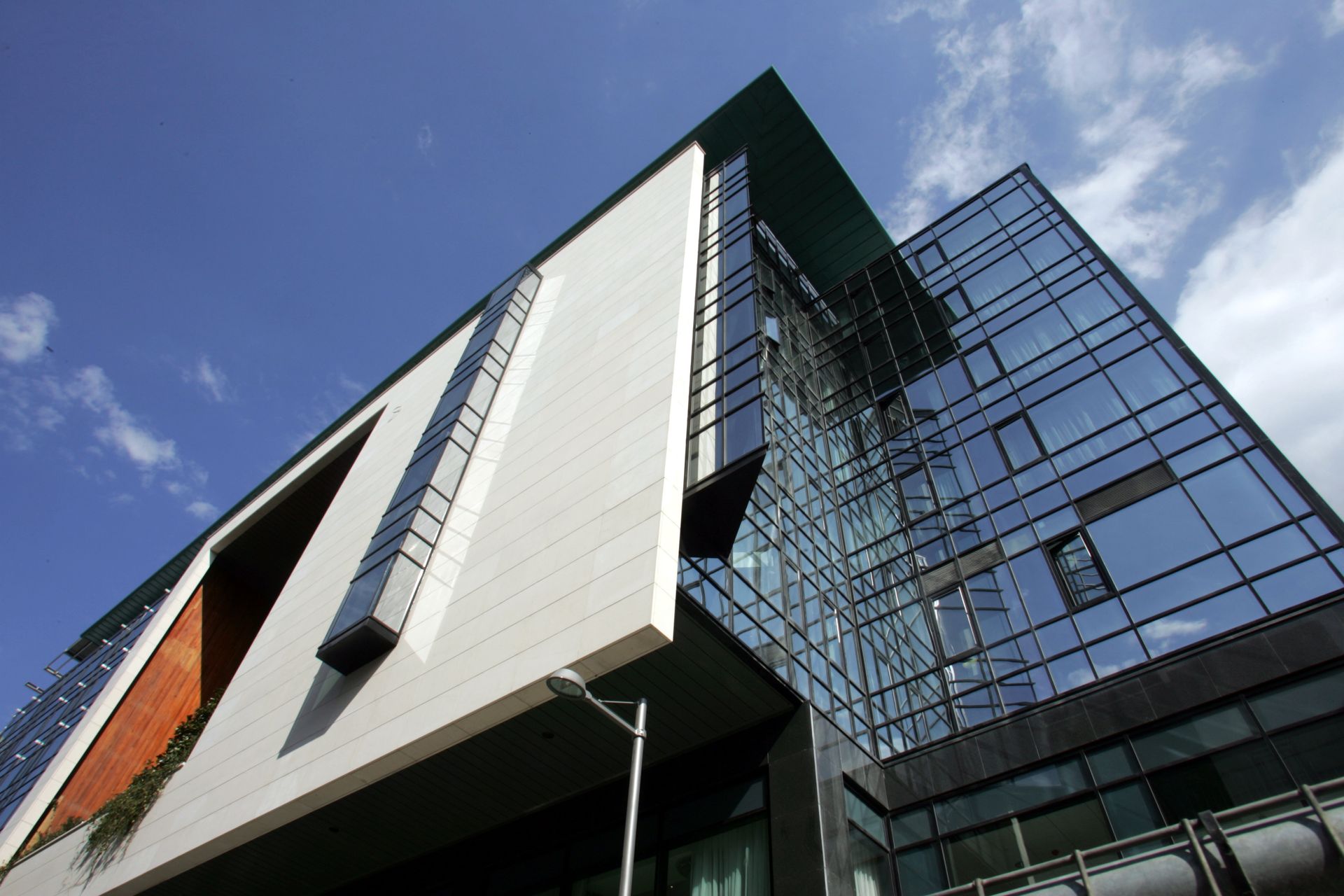 A tall building with a lot of windows against a blue sky