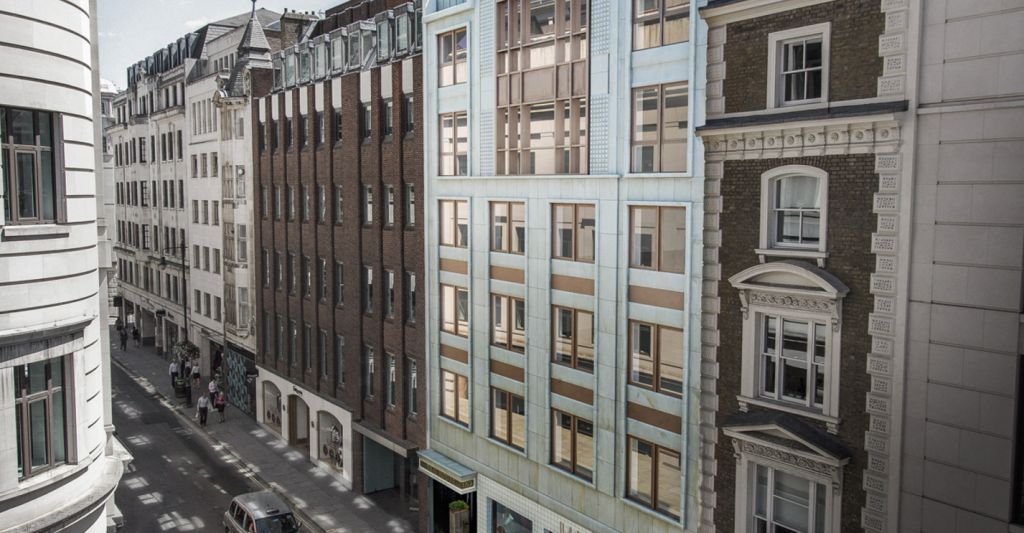 An aerial view of a city street with lots of buildings and cars.