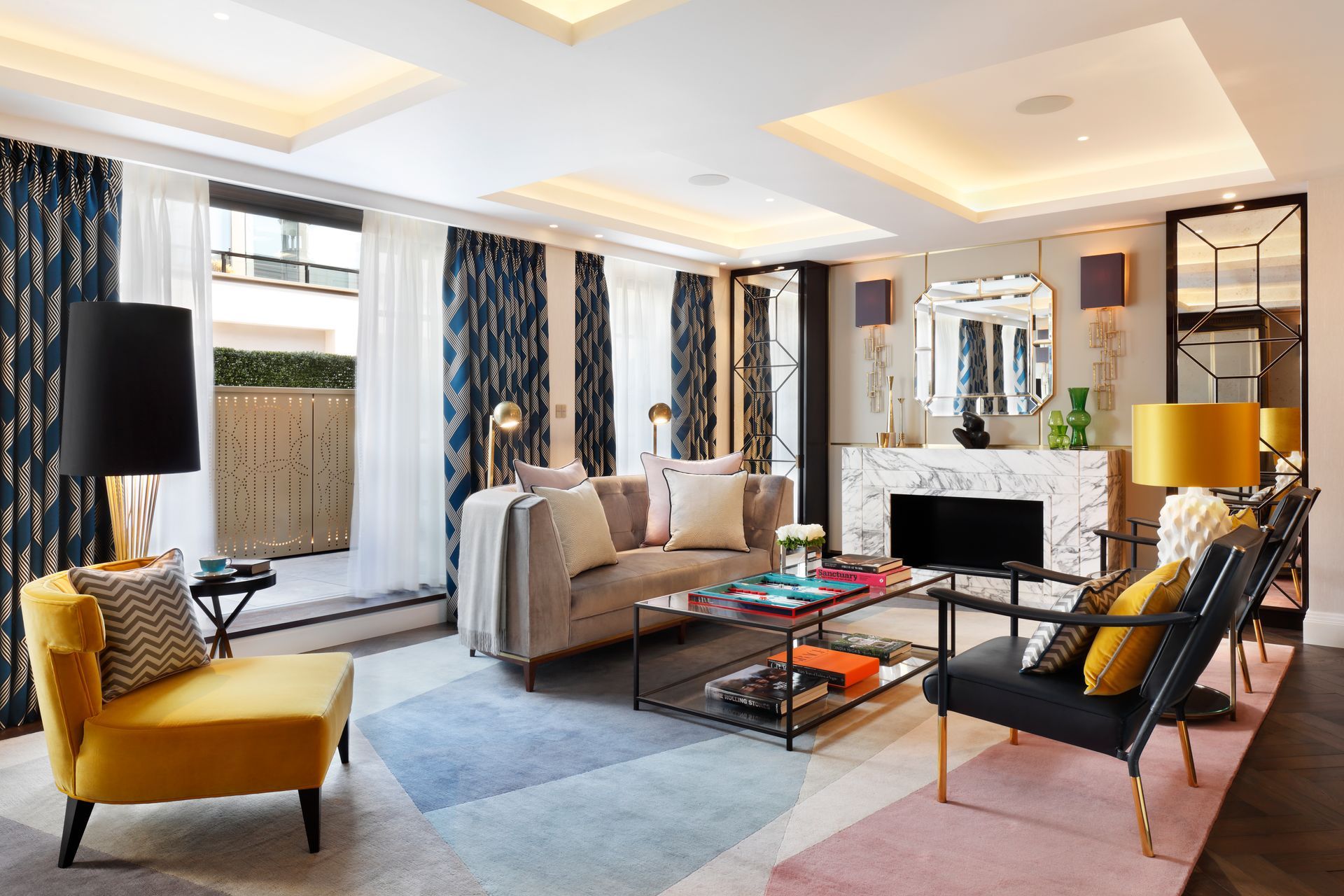 A living room with a couch , chairs , coffee table and fireplace.