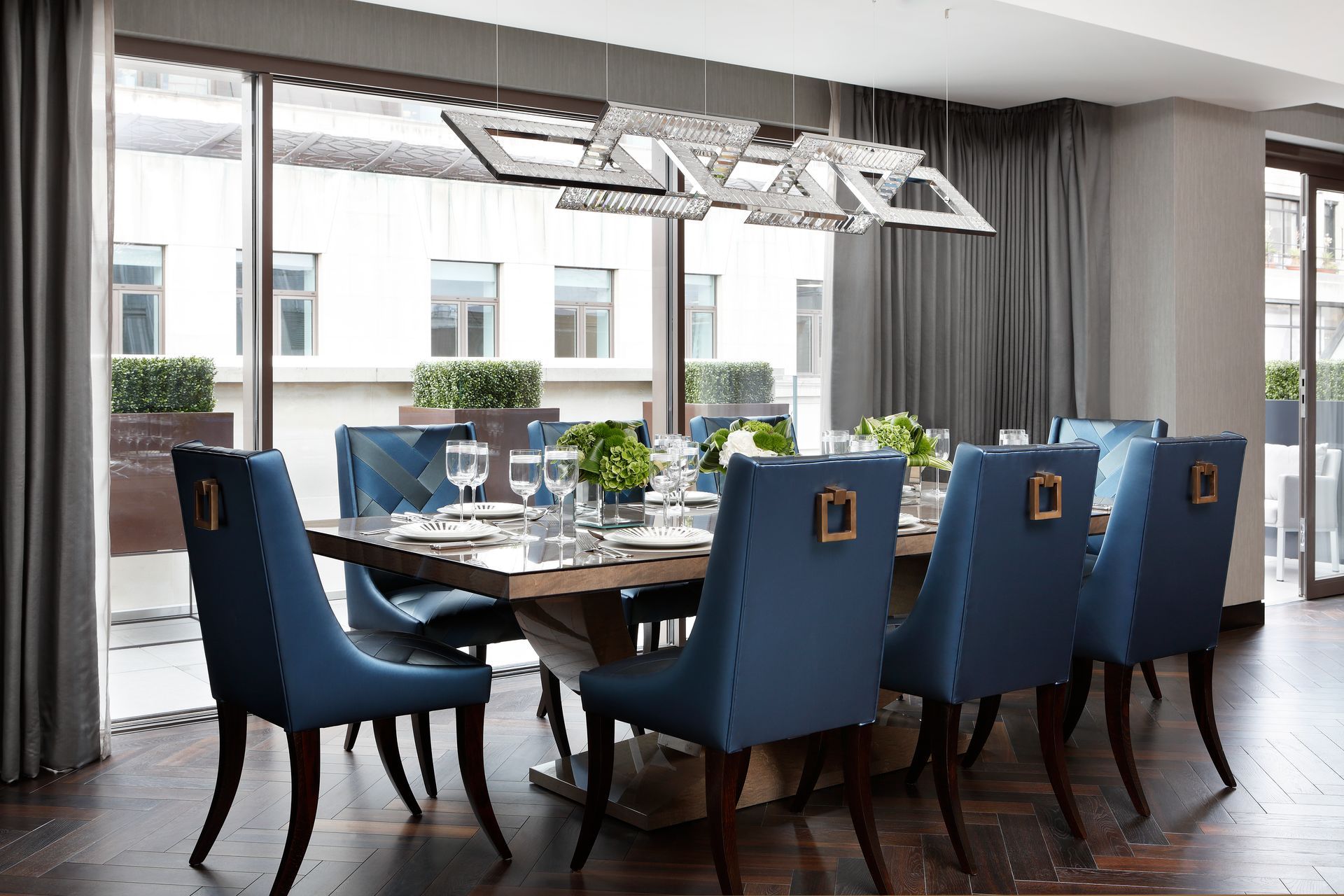 A dining room with a long table and blue chairs