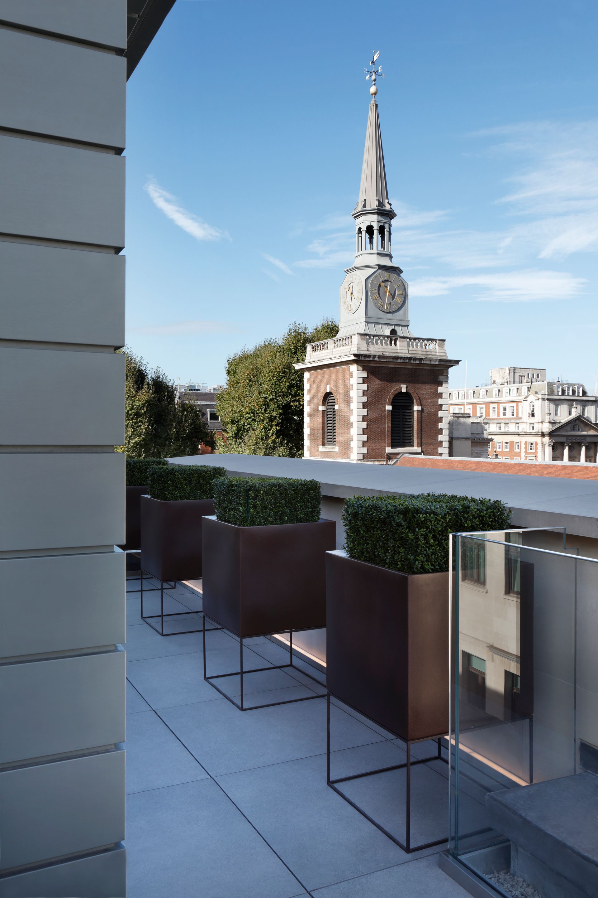 A balcony with a clock tower in the background