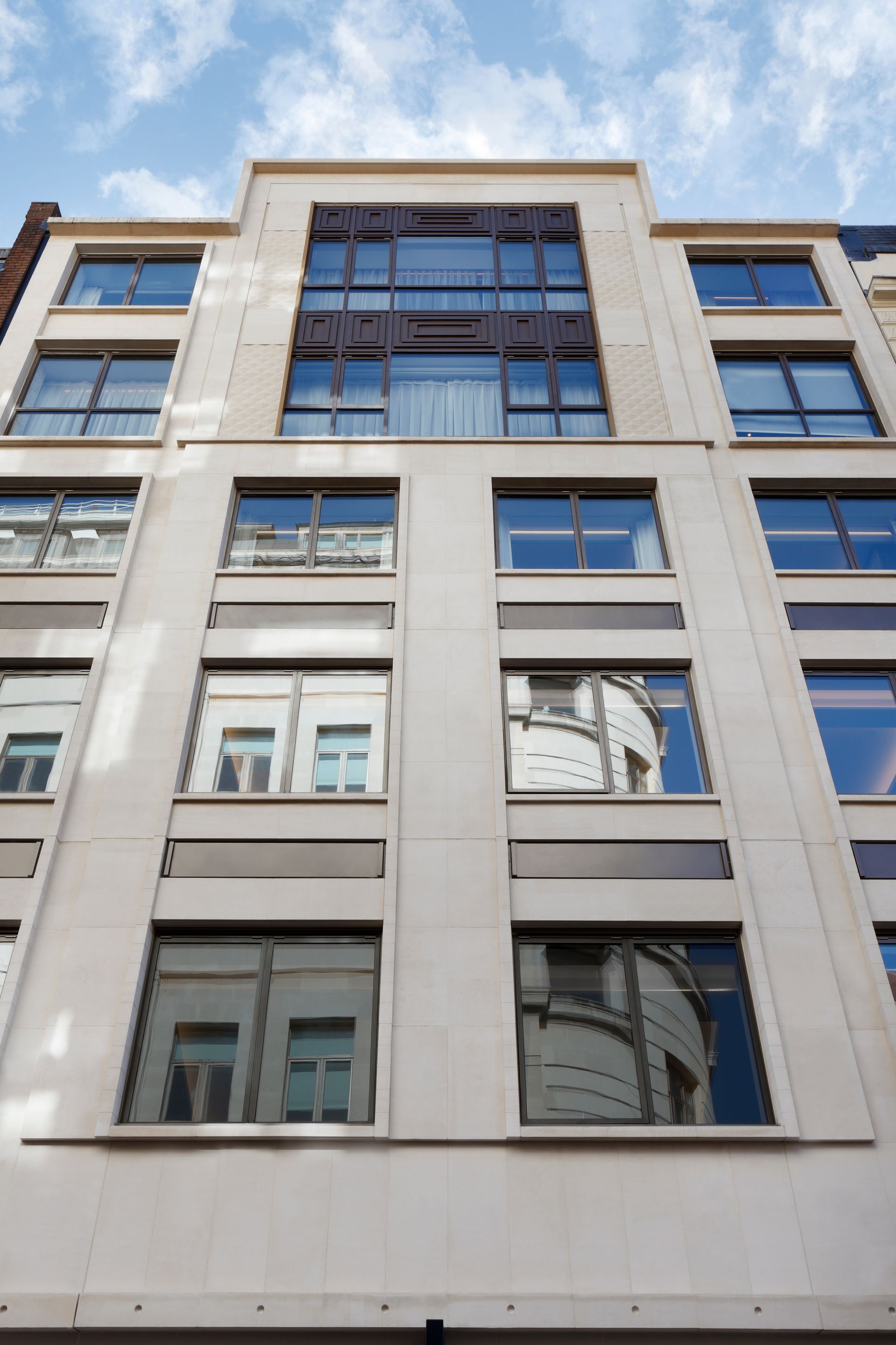 Looking up at a tall building with lots of windows