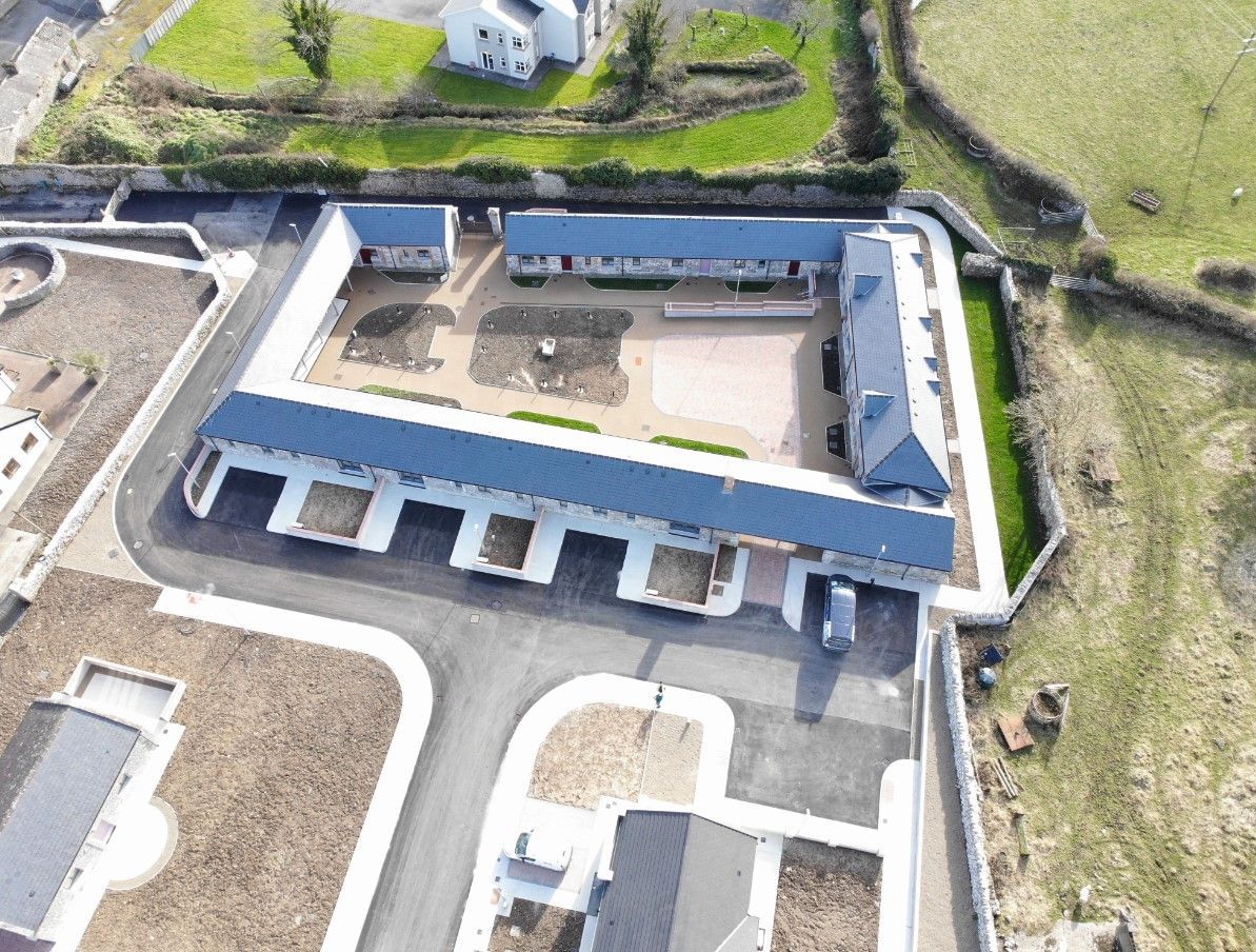 An aerial view of a building with a blue roof