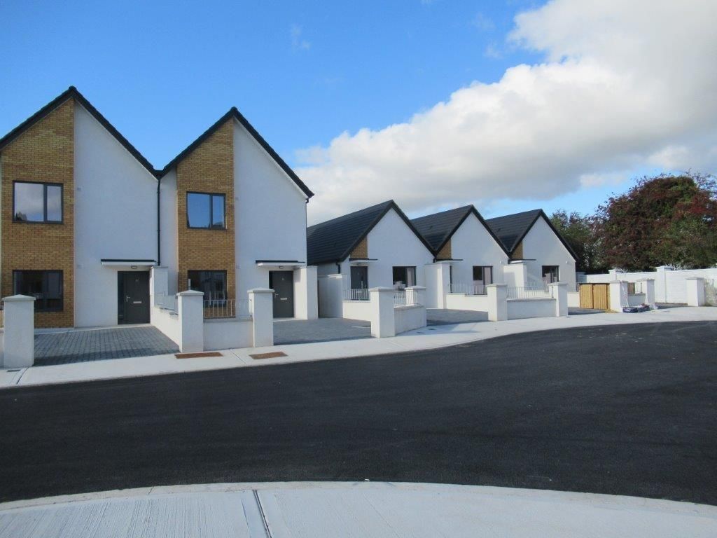A row of houses with a blue sky in the background