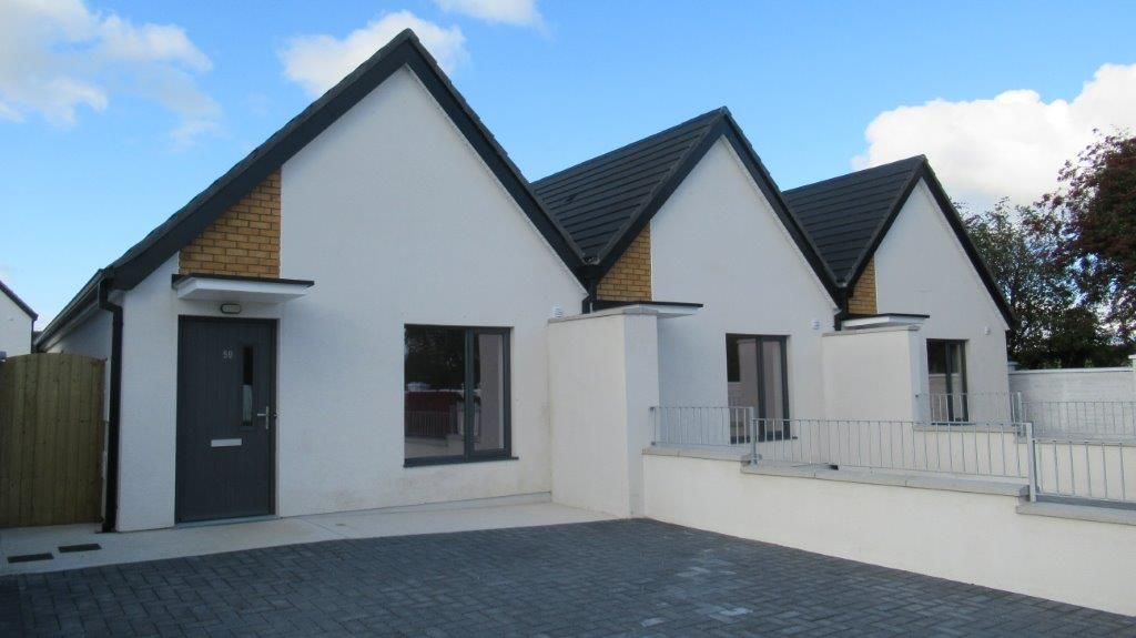 A row of white houses with black roofs