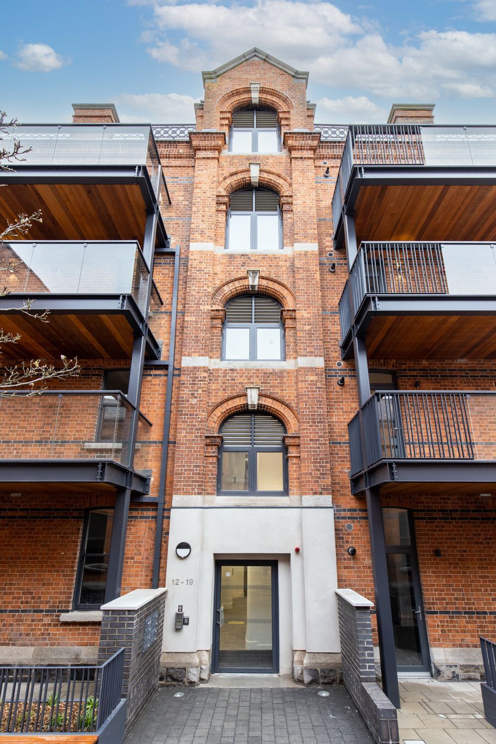 A large brick building with a lot of windows and balconies.