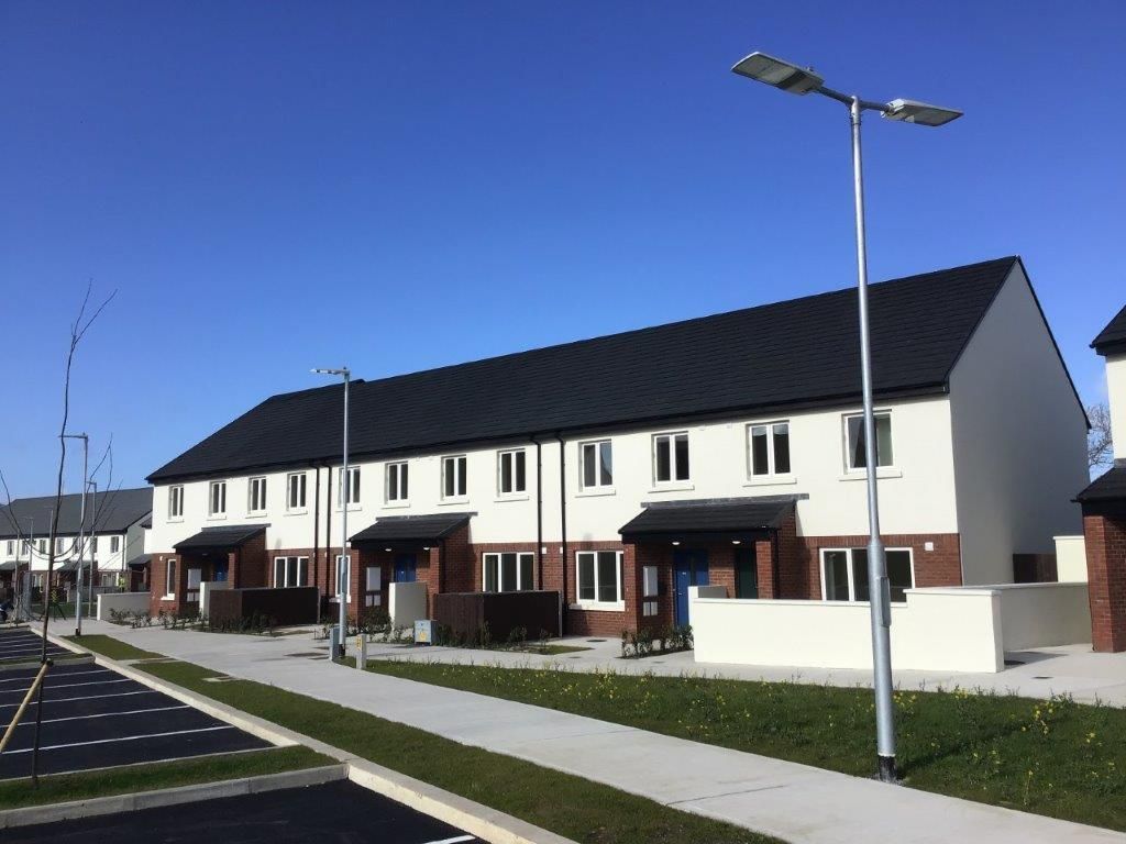 A row of houses in a residential area with a blue sky in the background