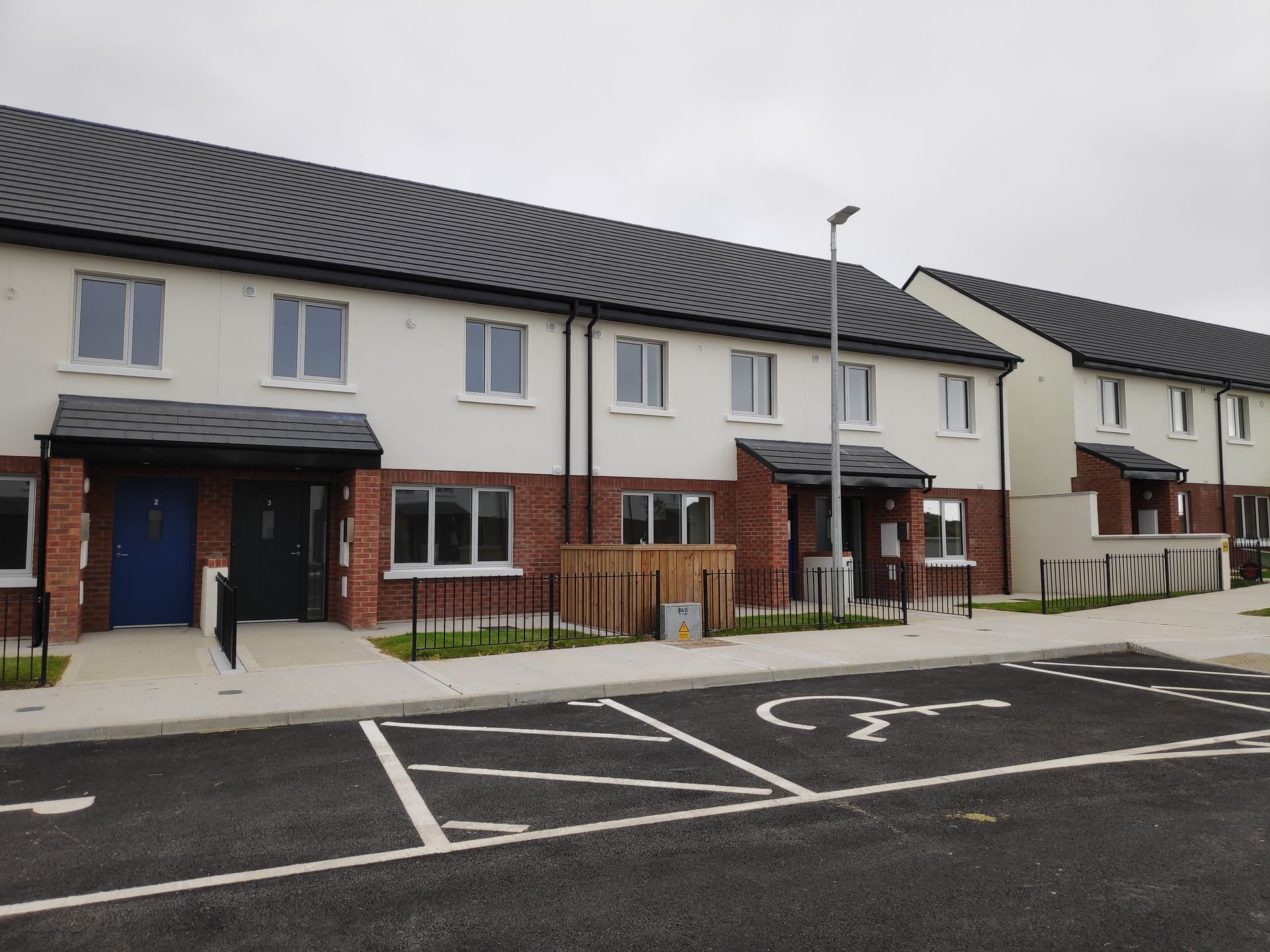 A row of houses with a handicapped parking spot in front of them