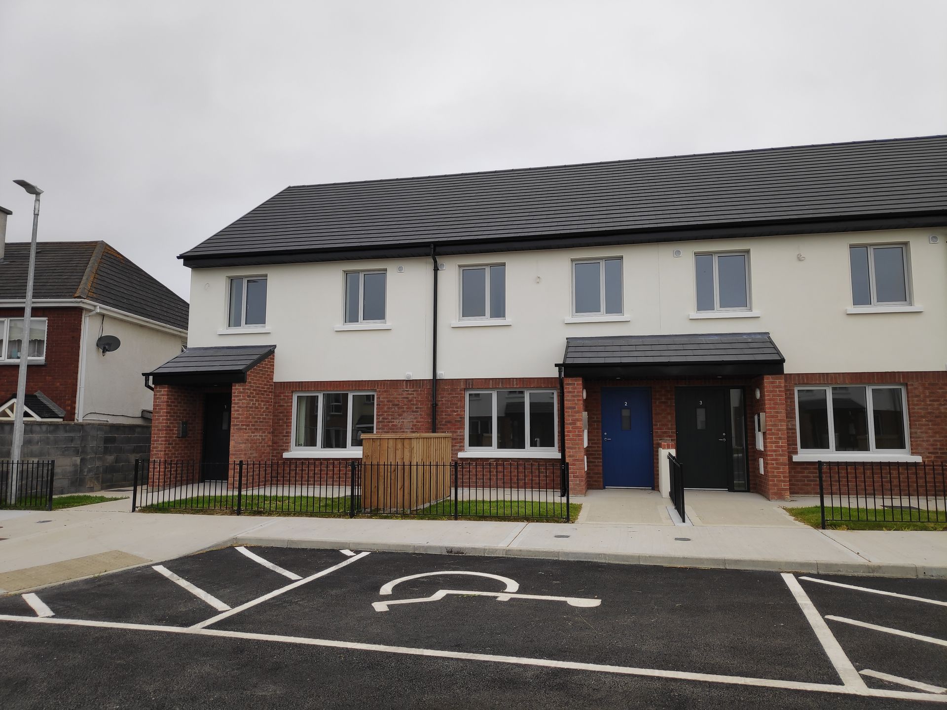 A building with a handicapped parking spot in front of it