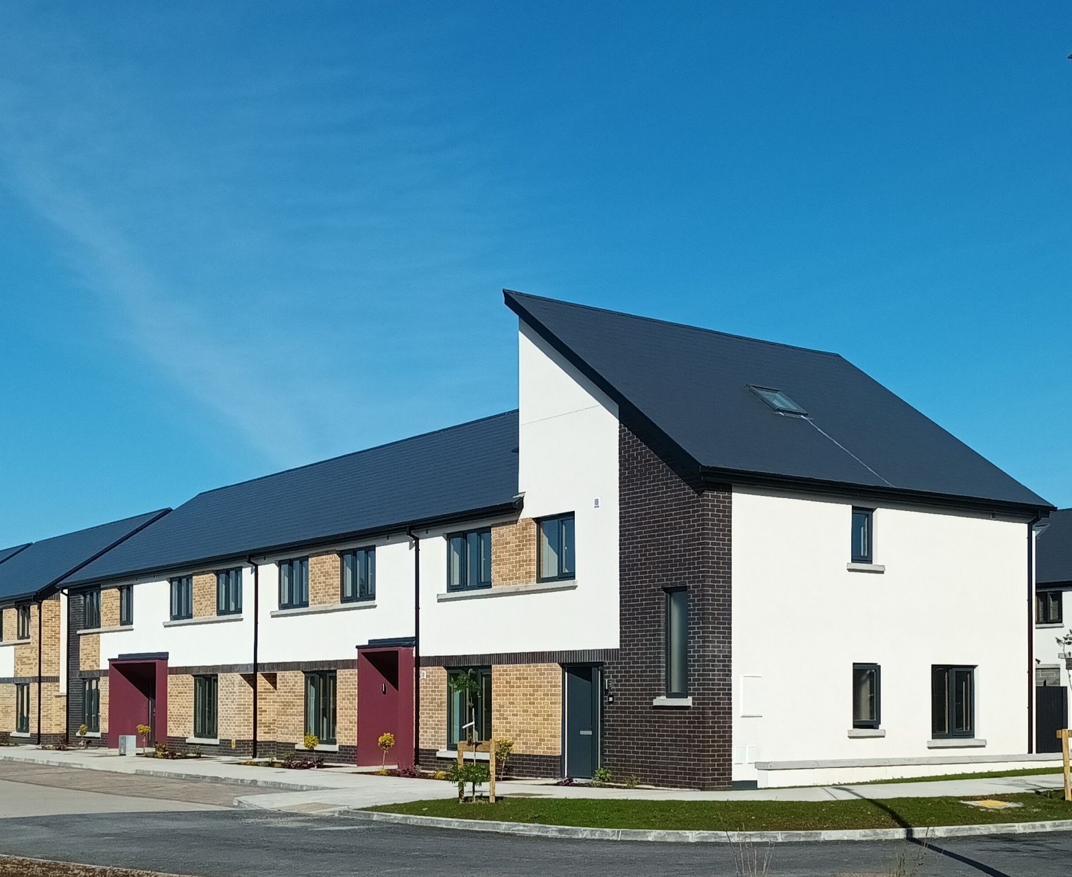 A row of houses with a blue sky in the background