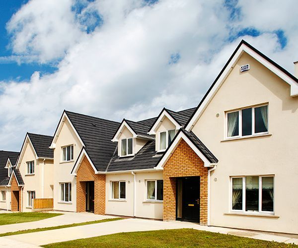 A row of houses with a blue sky in the background