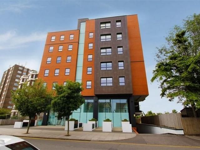 A large orange building with a lot of windows