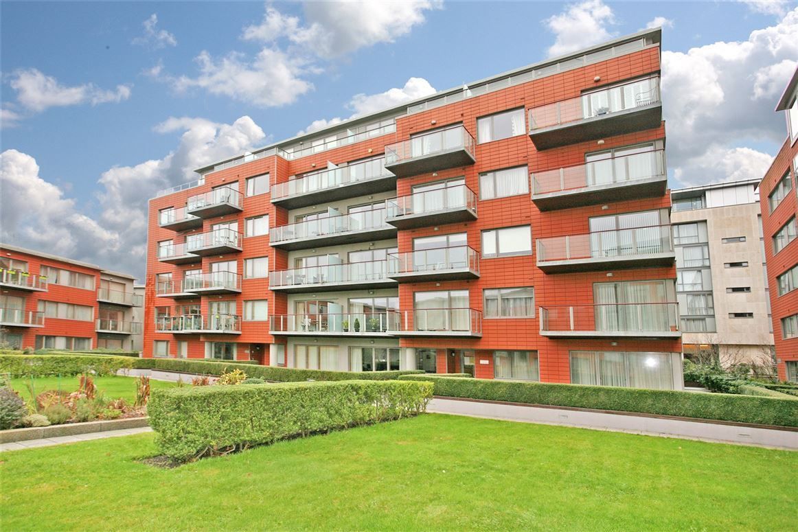 A large apartment building with a lot of windows and balconies