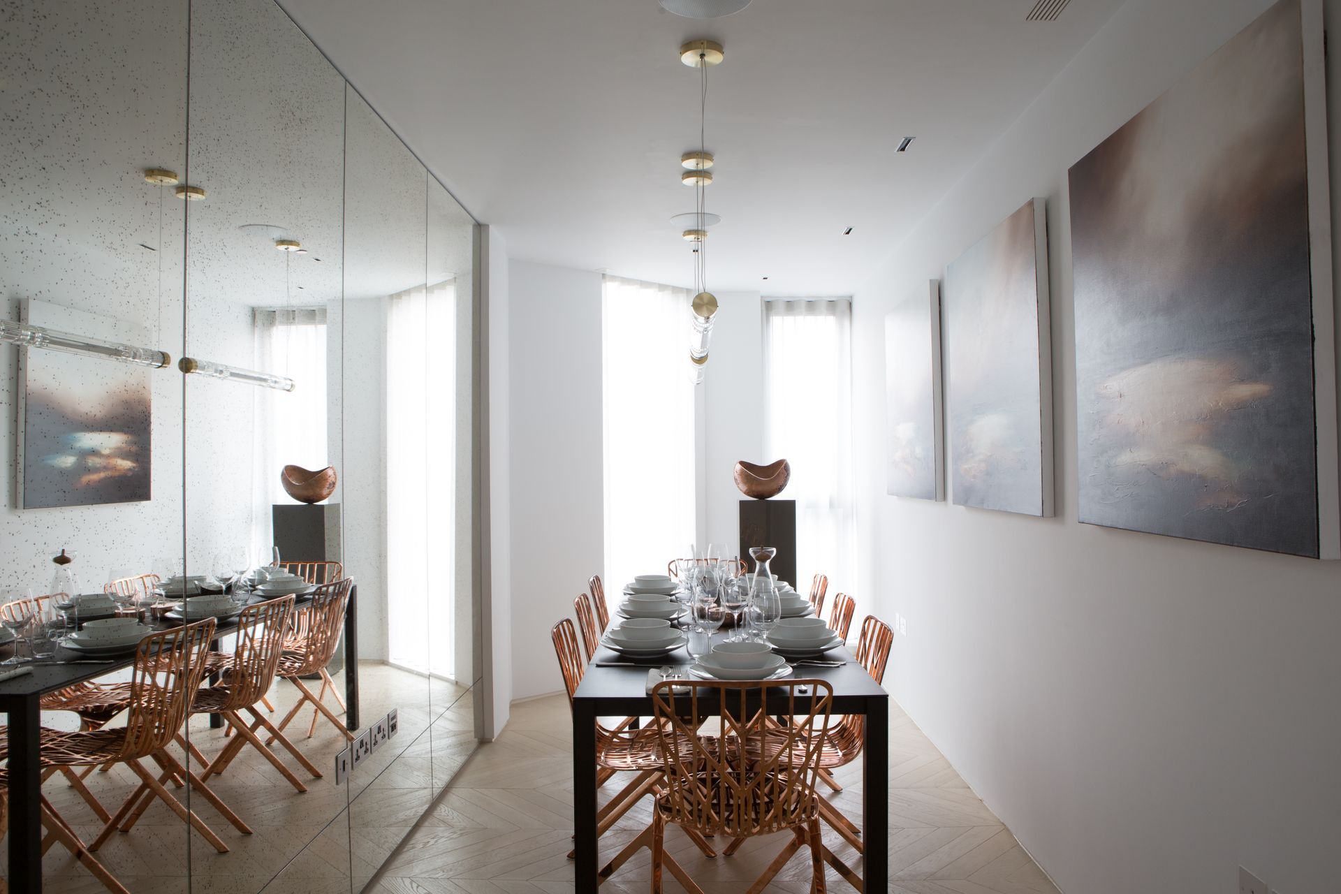 A dining room with a long table and chairs