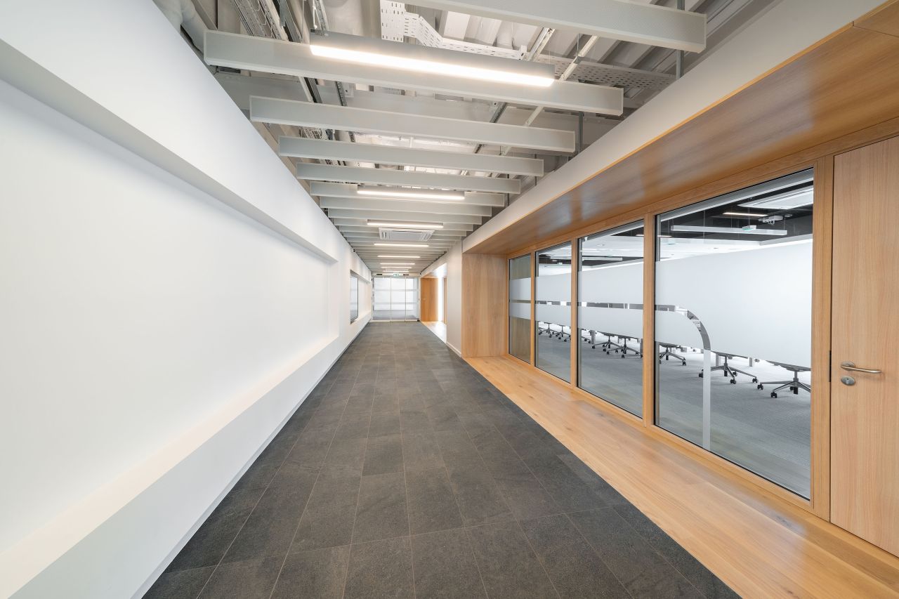 A long hallway with a conference room in the background